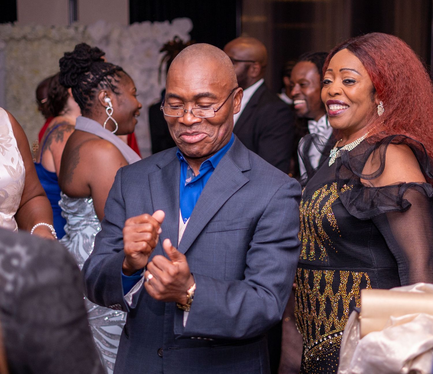 Party guests dancing and enjoying themselves at a formal celebration.