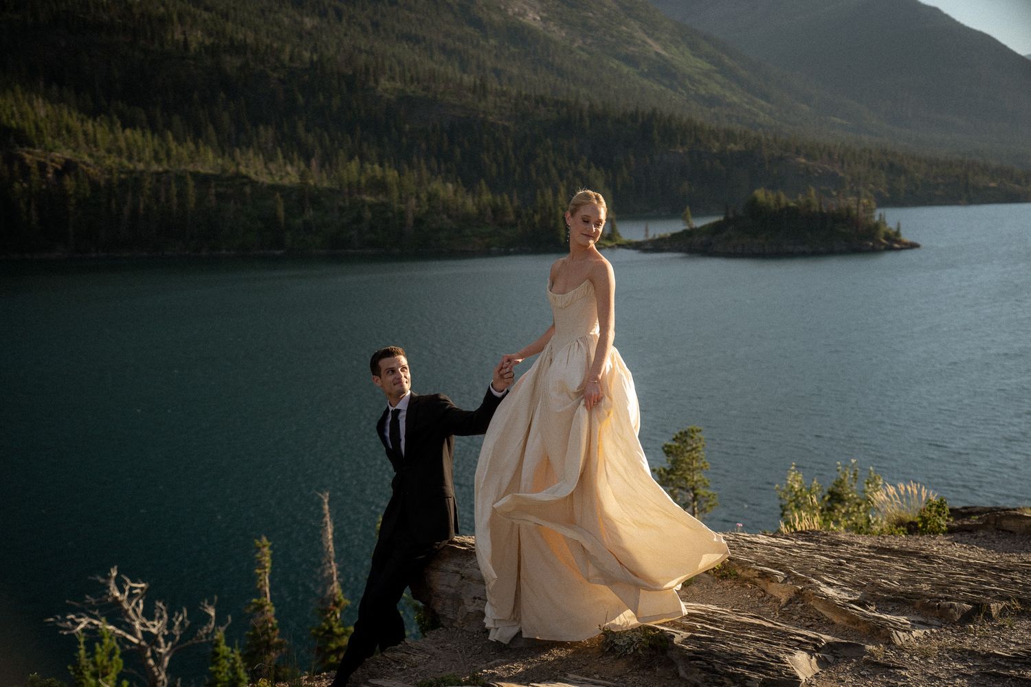 Bride and grrom pose during their beachfront elopement