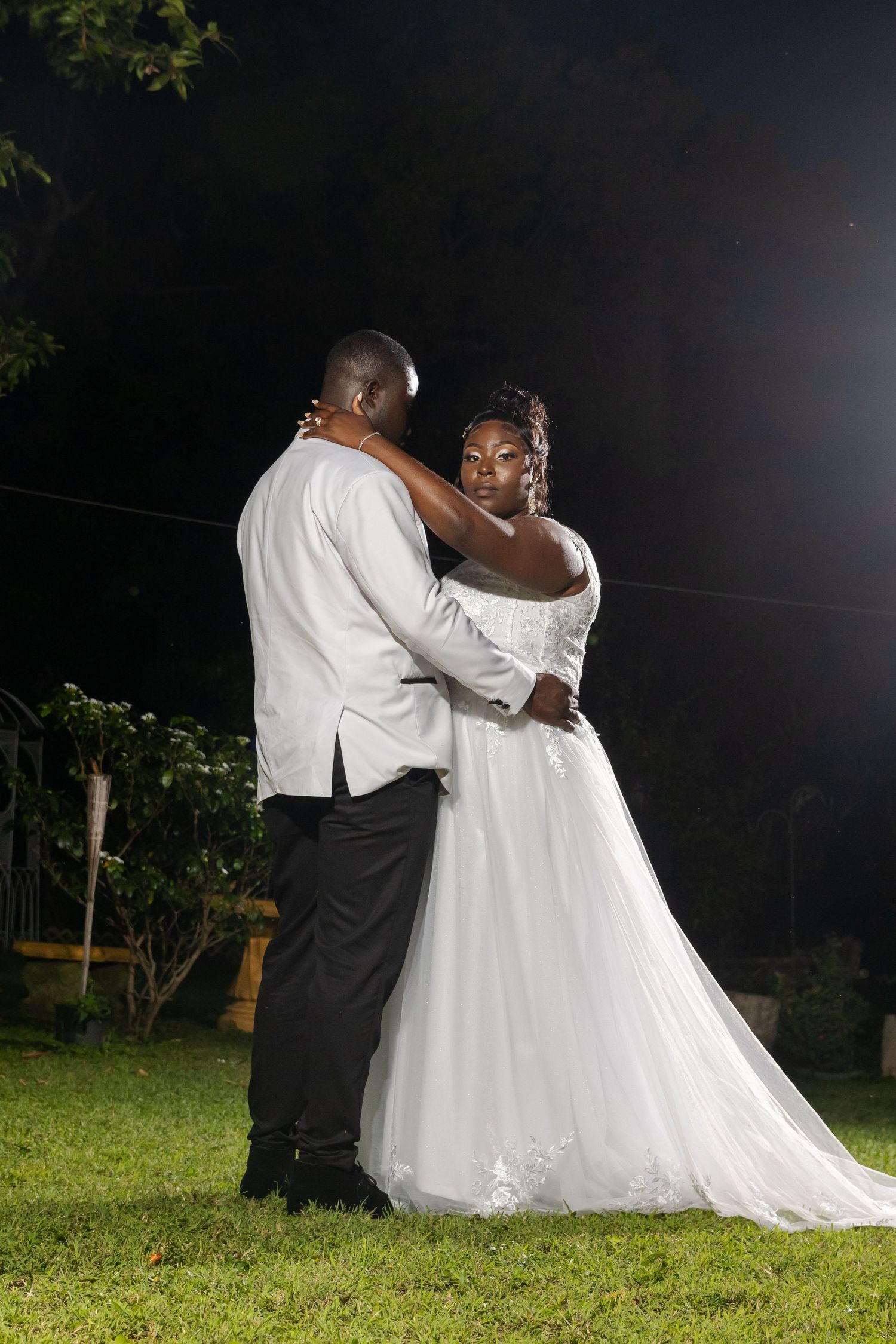 Bride and Groom Based in Jamaica, standing in white dress as wedding photographer takes images for an amazing wedding album in Jamaica