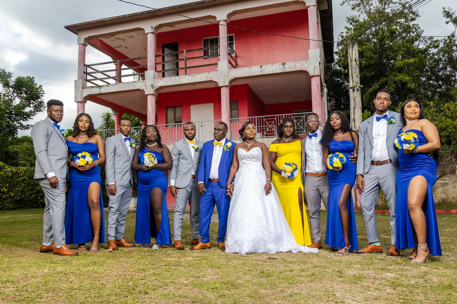 Bridal Party in Blue white and yellow standing while the wedding photographer takes stunning wedding portraits for a wedding Instagram