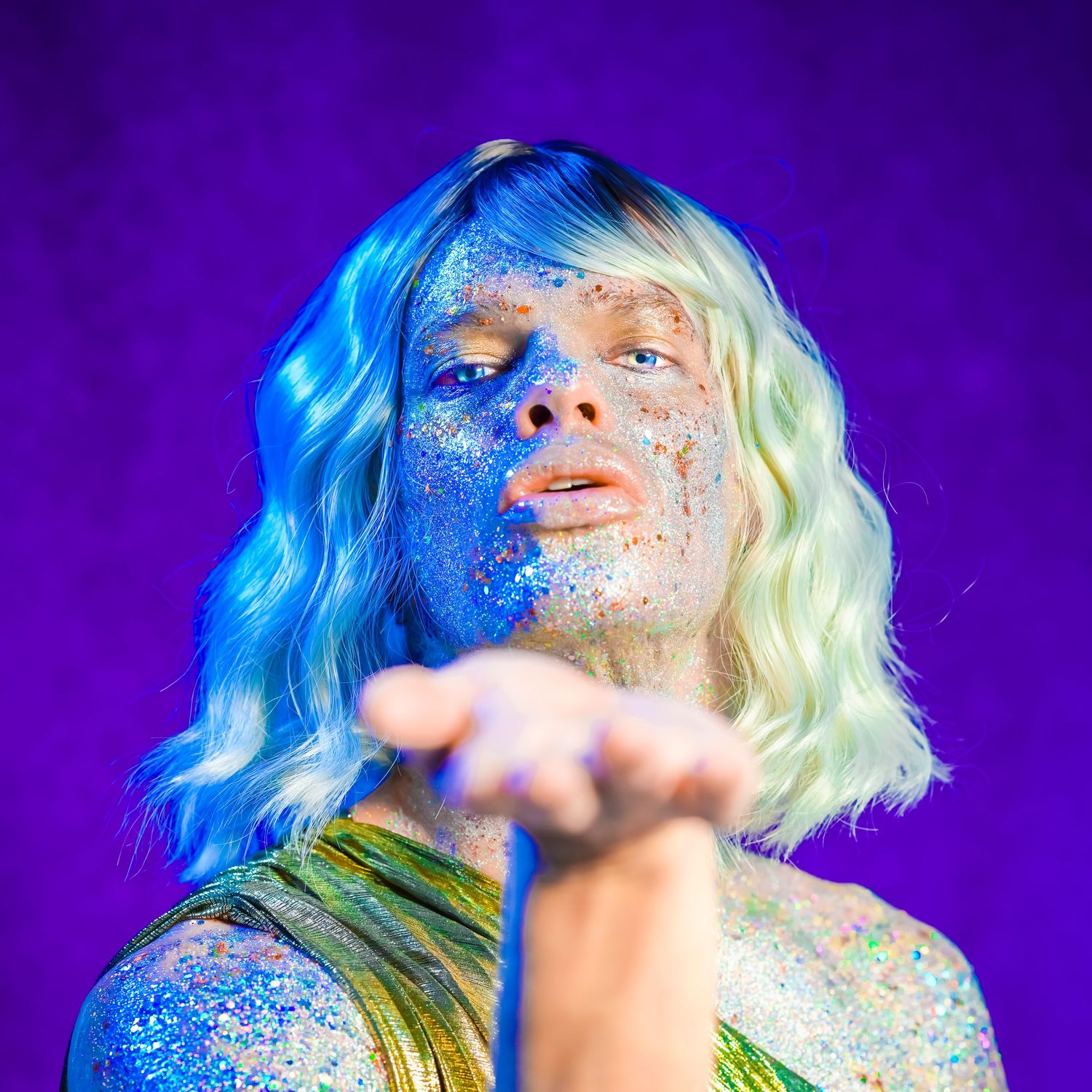 Artistic portrait with sparkles and dramatic purple lighting effects.