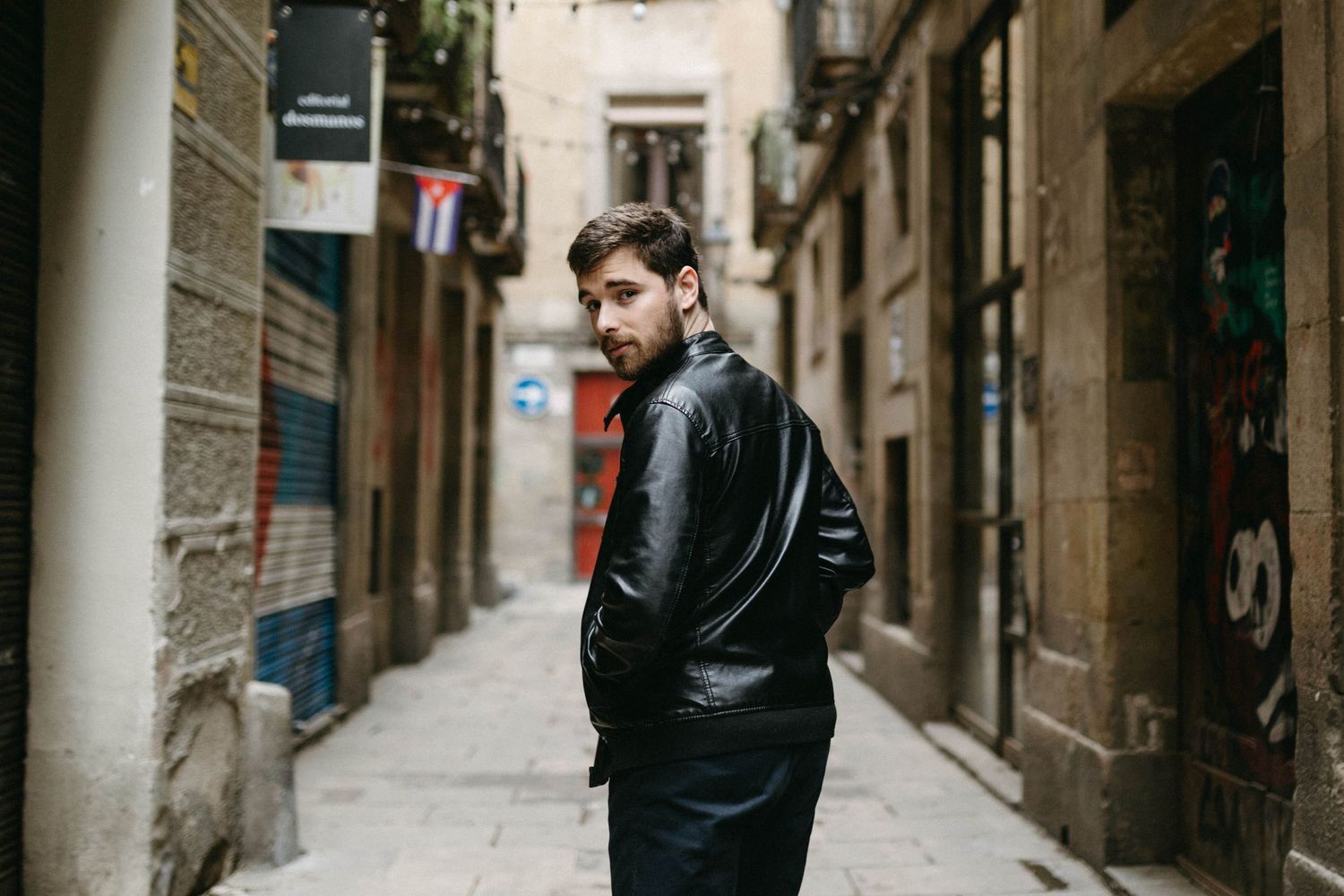 A couple explores the narrow cobblestone streets and historic architecture of Barcelona's Gothic Quarter.