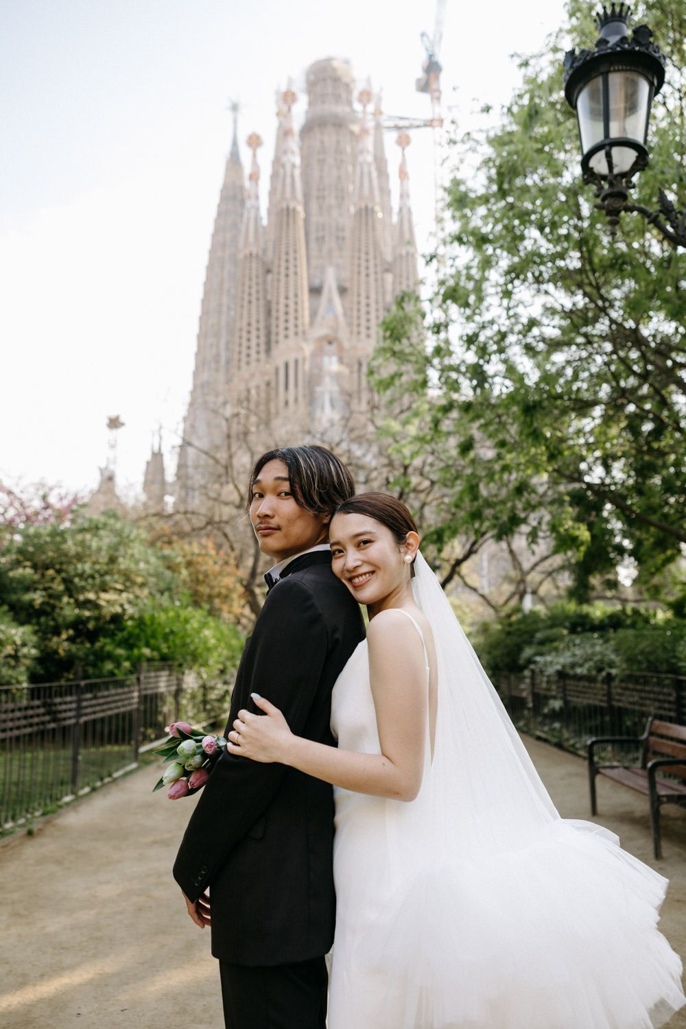 Wedding photoshoot with iconic Sagrada Familia cathedral as backdrop in Barcelona.
