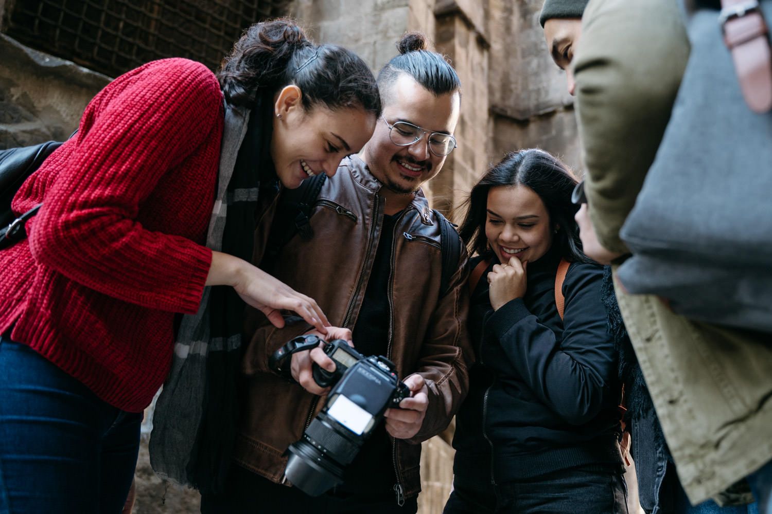 Photographer capturing creative angles and portraits in front of historic architecture.