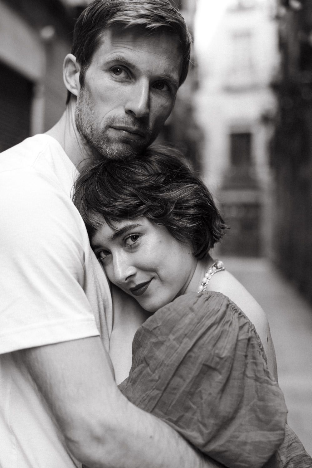 Black and white photo sequence showing a couple in an intimate embrace against a blurred background.