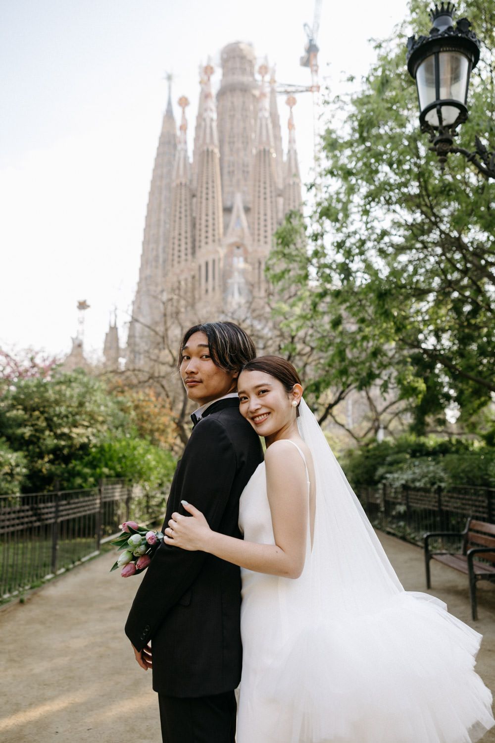 Wedding photography session at the Sagrada Familia with couple sharing joyful moments.
