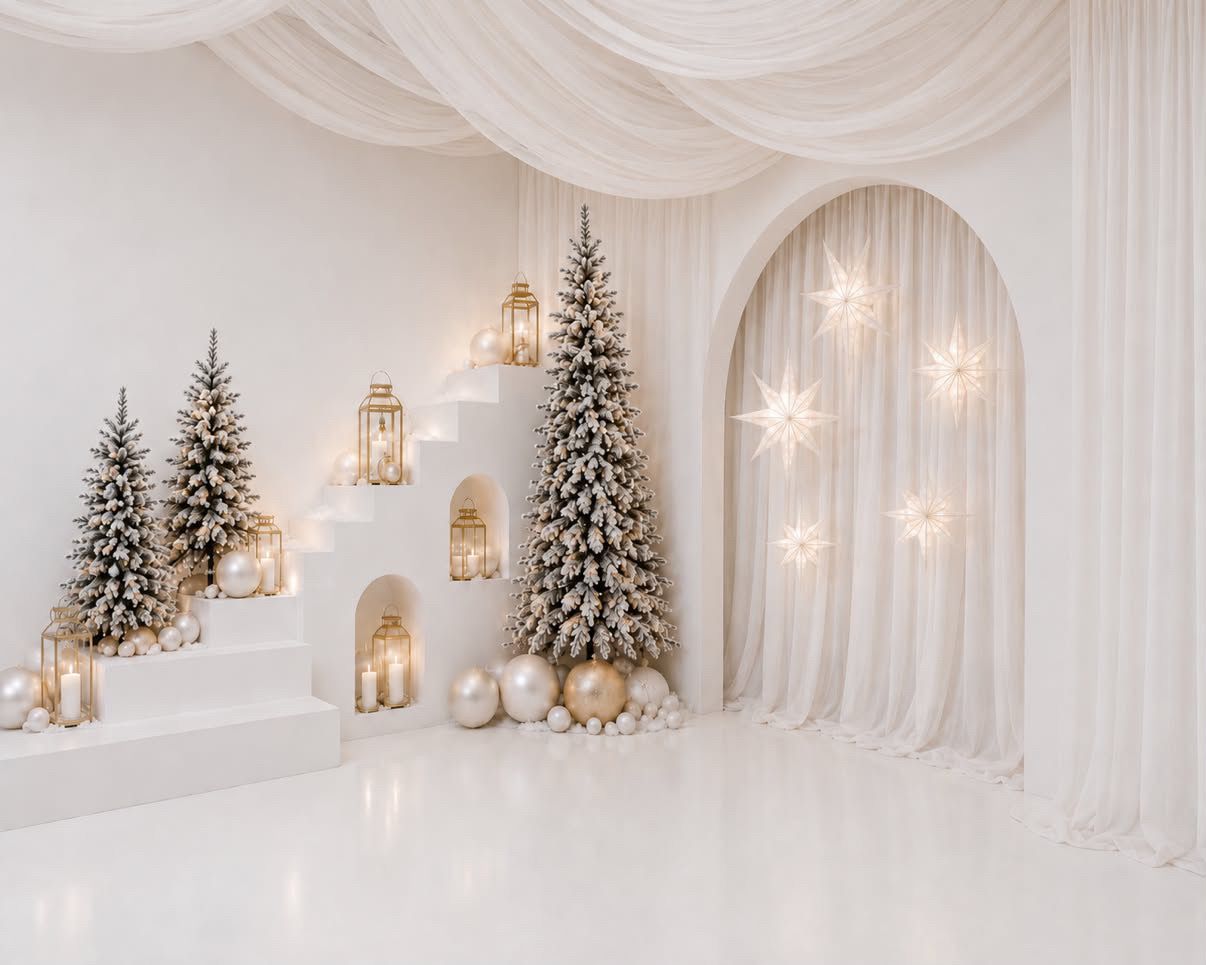 White Christmas studio backdrop with flocked trees, gold ornaments, lanterns, glowing stars and draped sheer curtains in an arched alcove.