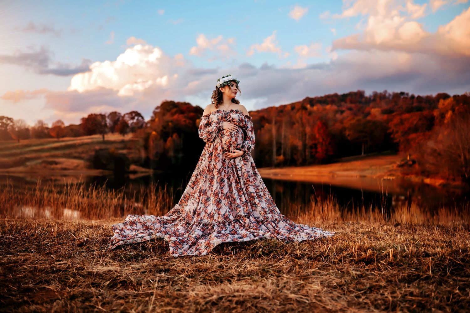 A flowing dress billows dramatically across a golden autumn field at sunset, creating an ethereal outdoor scene.
