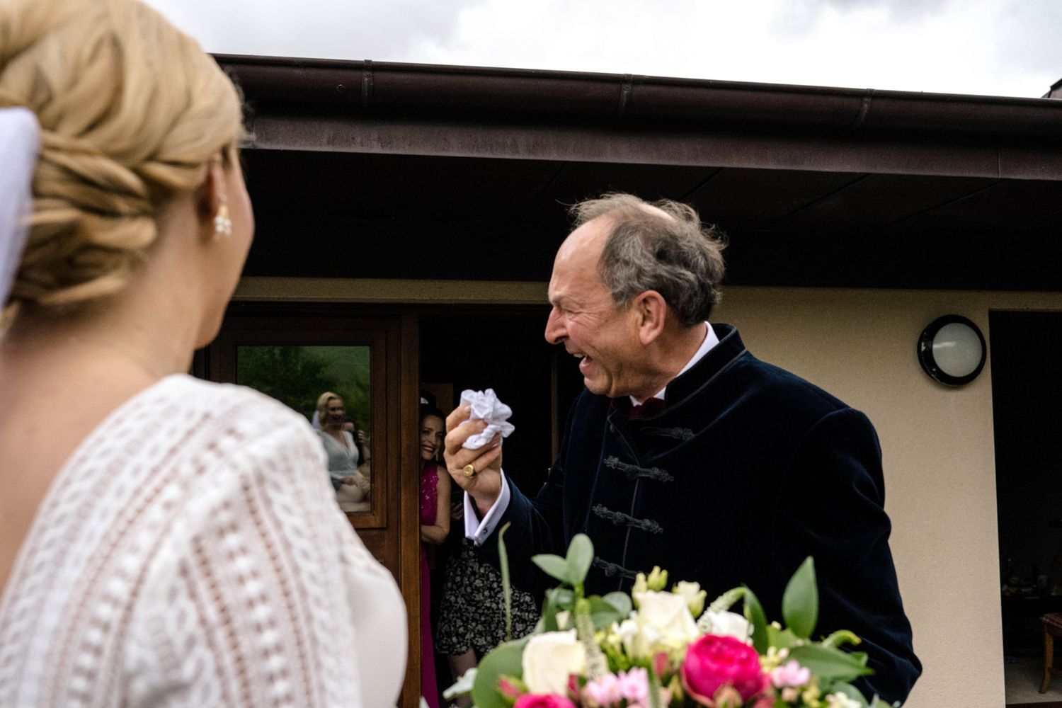 Emotional moment captured between wedding guests during an outdoor ceremony.