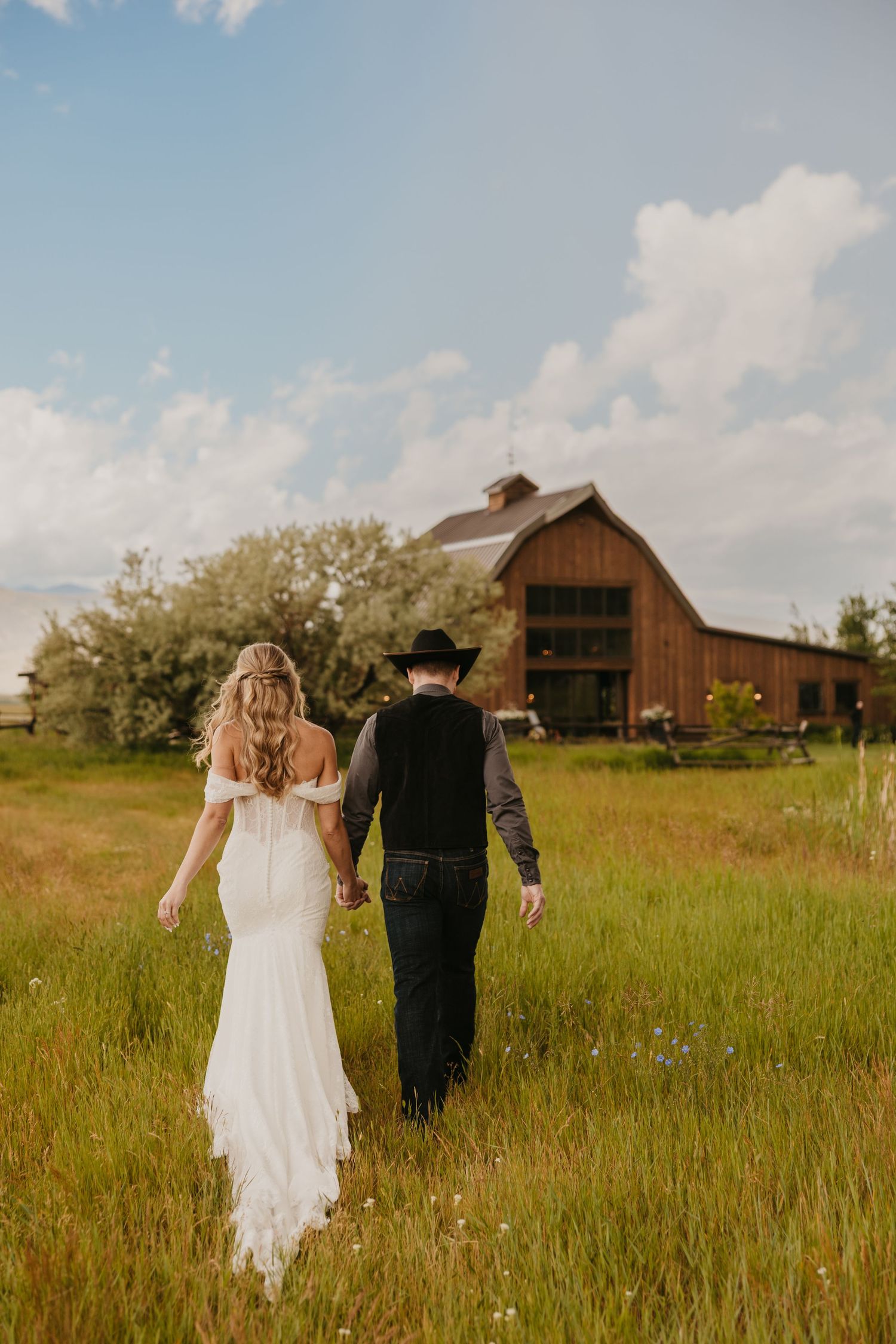 Copper rose ranch Venue with a bride and groom walking to their reception space in Paradise Valley Montana near Emigrant, Montana