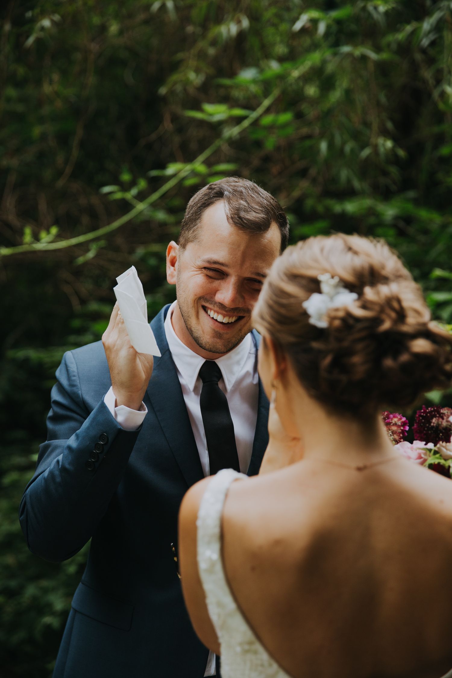 An emotional moment captured between a couple during their forest wedding ceremony.