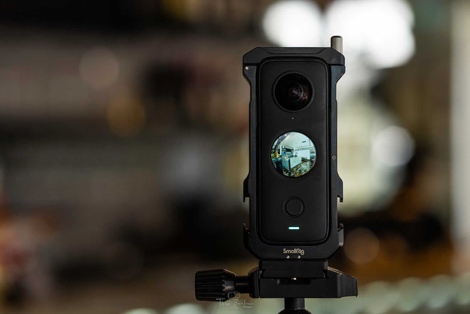 Professional camera equipment with glowing blue digital display mounted on dark stand.