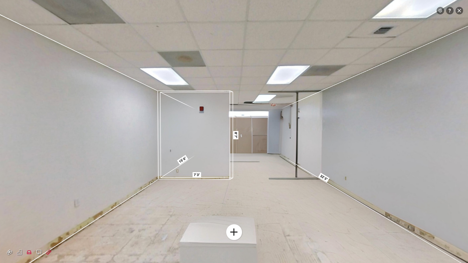 Empty office space under construction with white walls and fluorescent lighting.