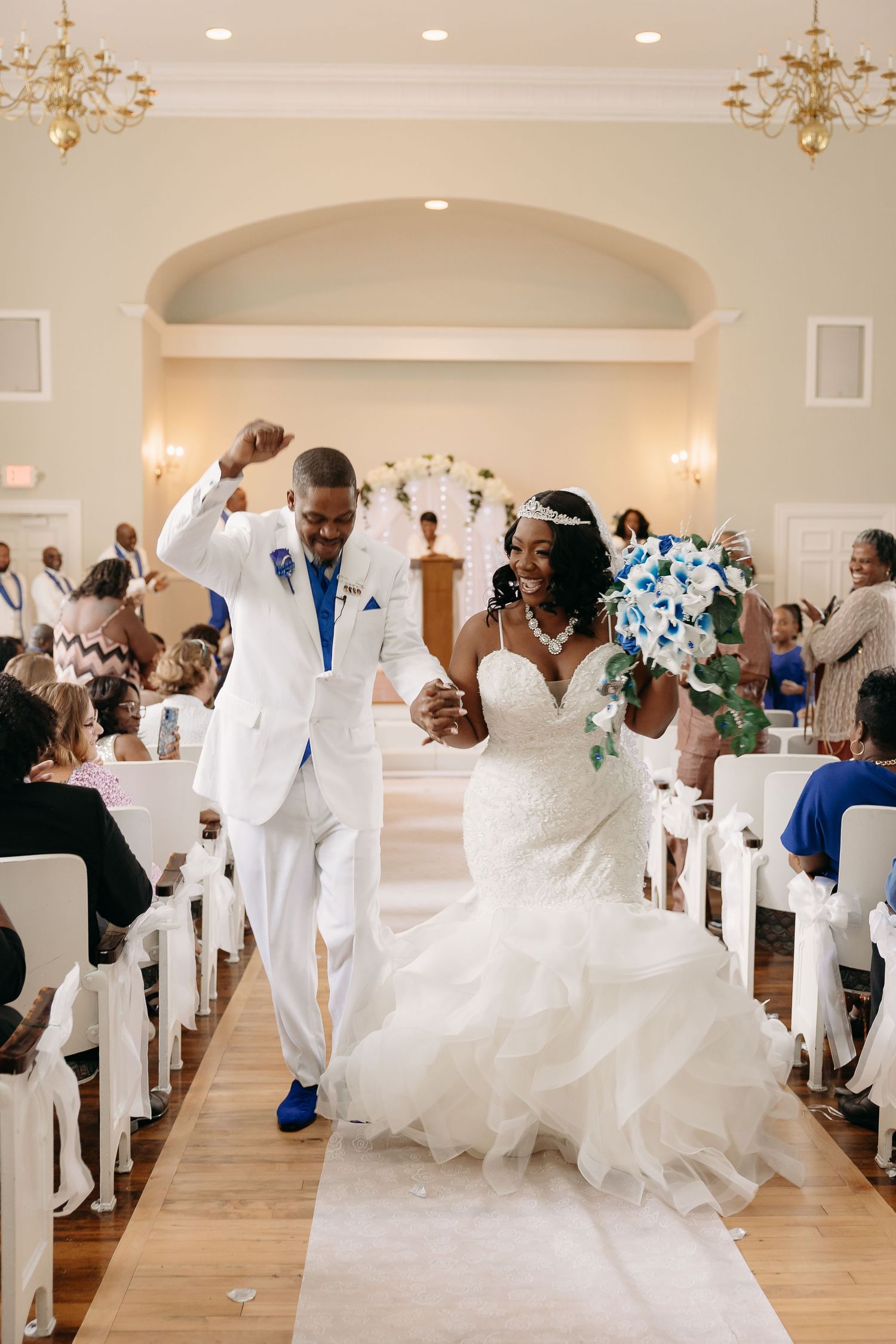 Joyful bride and groom celebrating as they walk down the aisle after their ceremony.