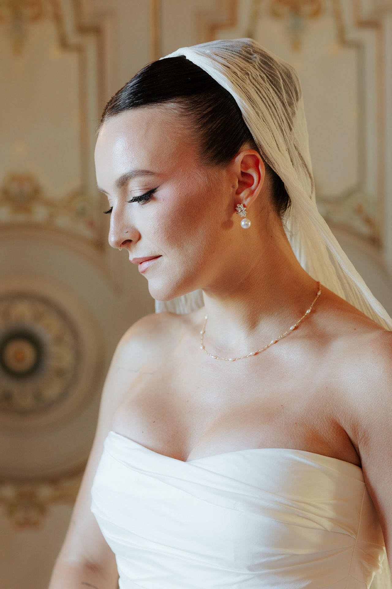 Elegant bridal portrait series showing close-up details of a strapless white wedding dress and delicate jewelry.