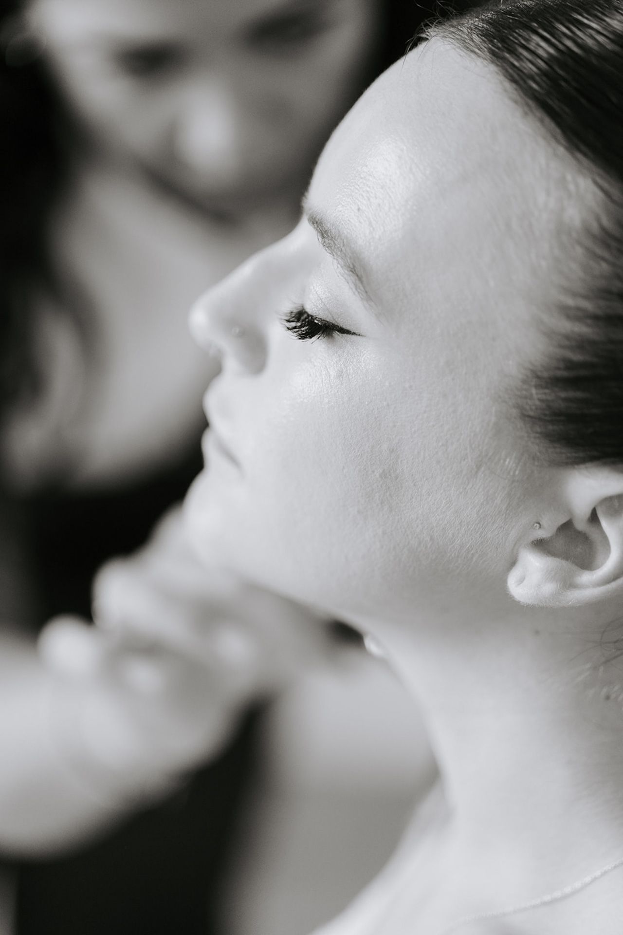 A series of black and white profile portraits showing a person's face from different angles in a minimalist style.