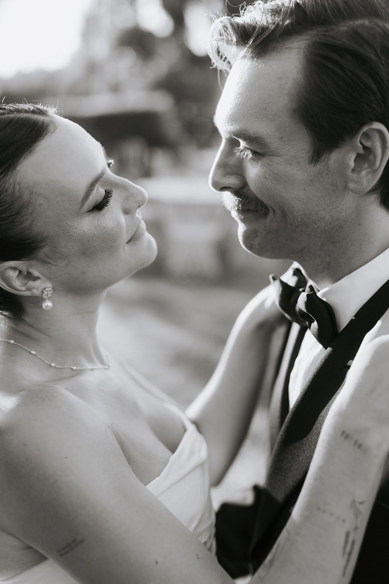 A series of intimate black and white wedding portraits showing tender moments between a bride and groom.