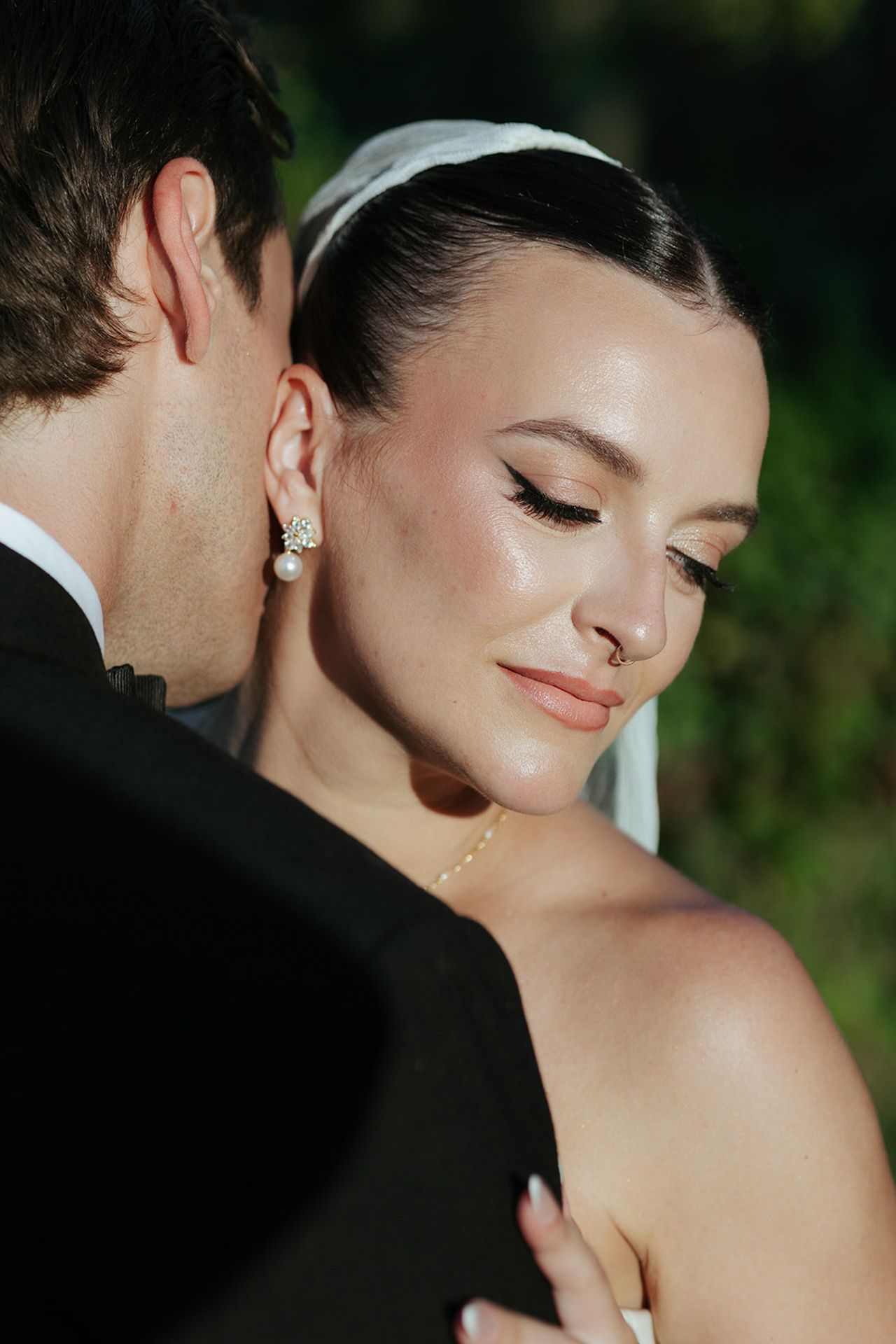 An intimate wedding portrait capturing a serene moment between the couple in natural lighting.