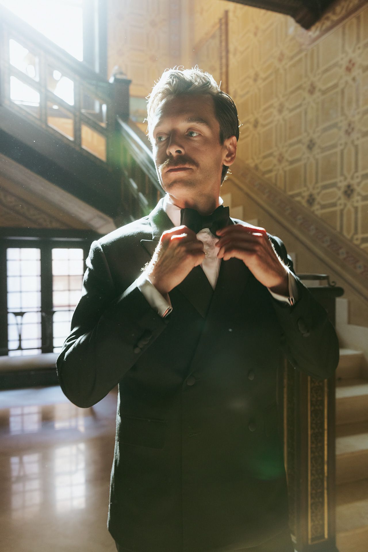 A series of photos showing someone adjusting a black bowtie in an elegant interior space with ornate walls.