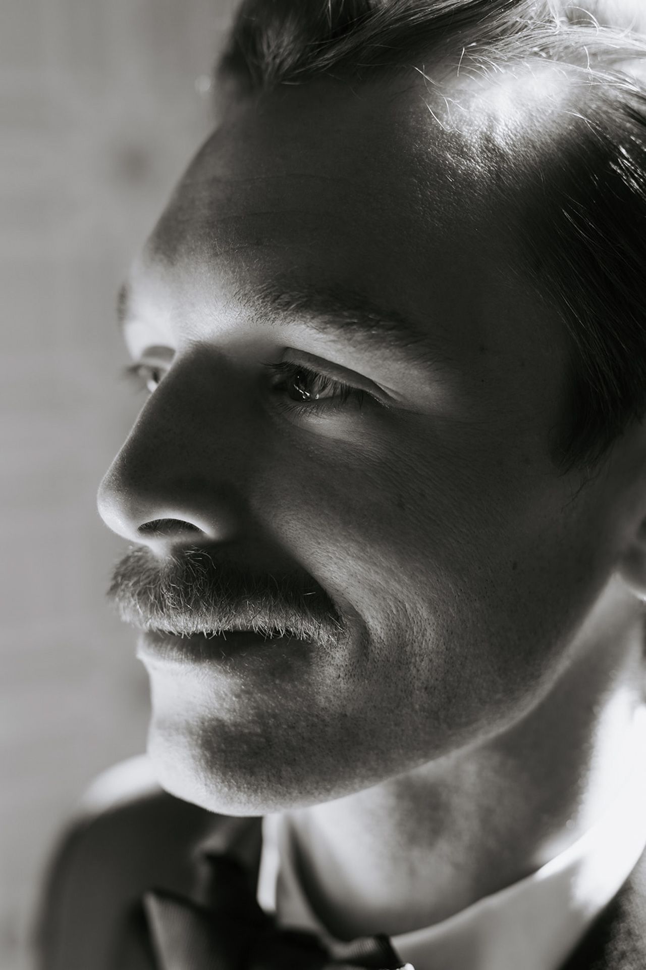 Black and white close-up profile view showing dramatic lighting and shadows.