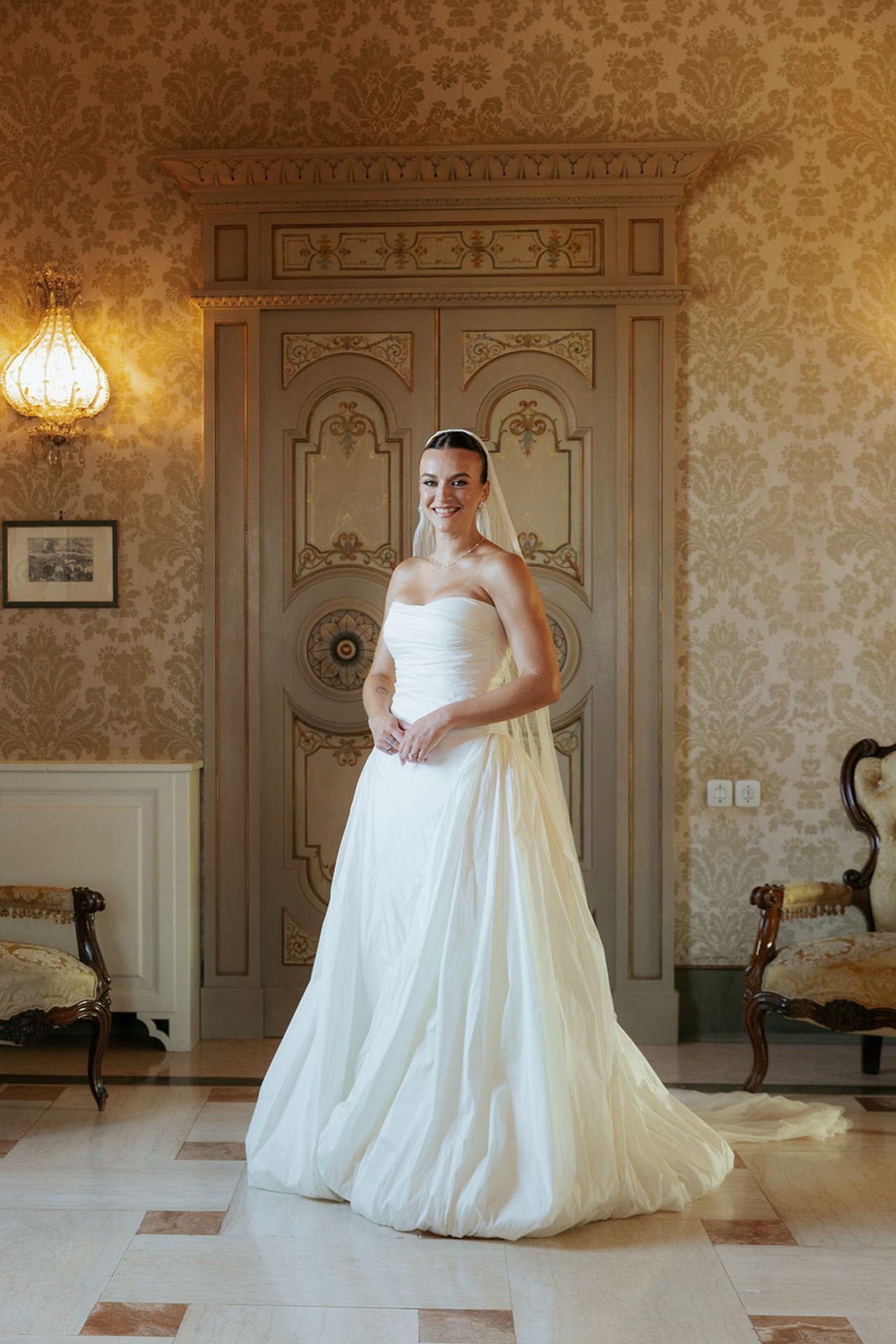 A sequence of photos showing a flowing white wedding dress in an elegant room with ornate wall details and warm lighting.
