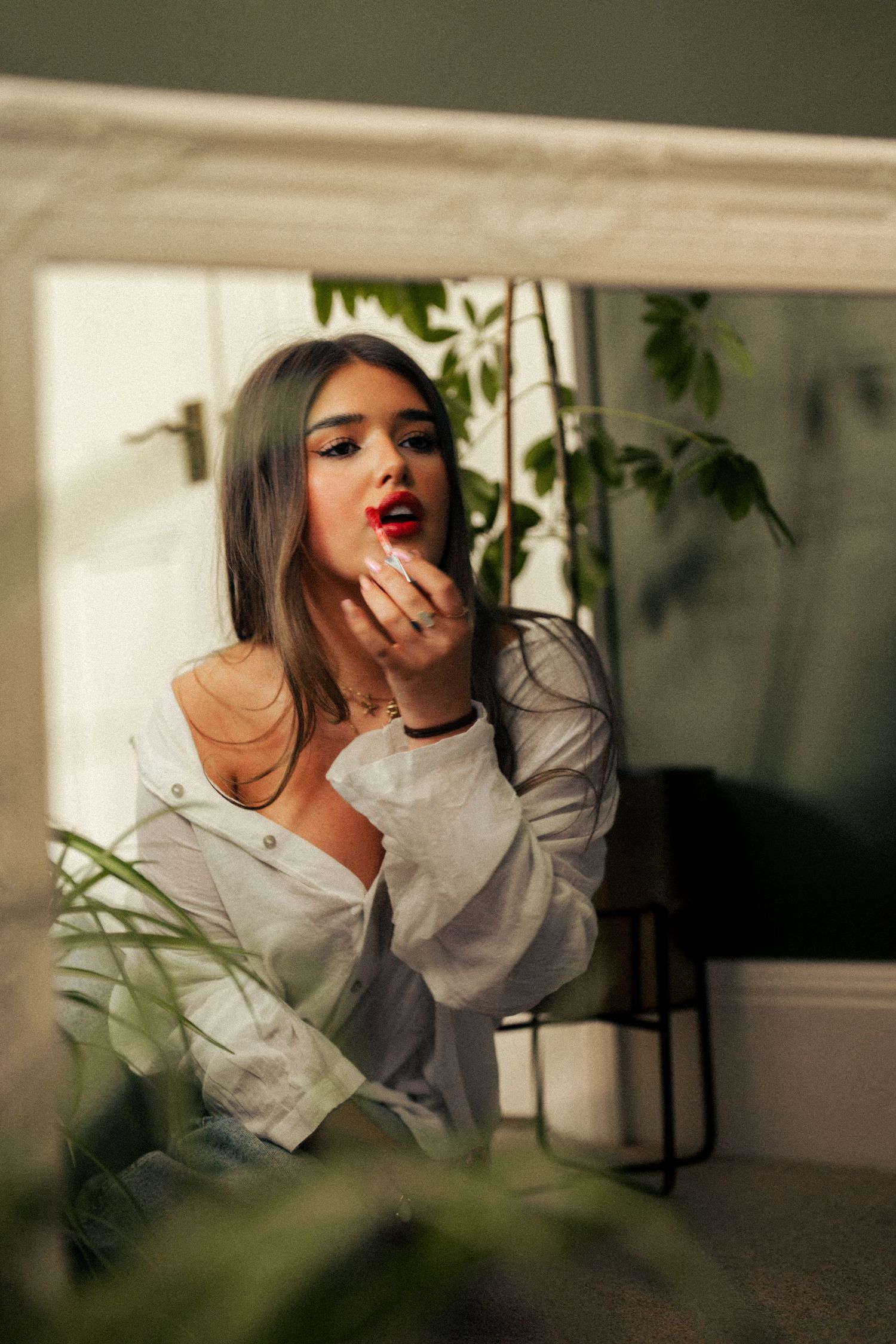 Dramatic indoor photoshoot with white shirt and natural lighting through plants. Harwich, Essex.