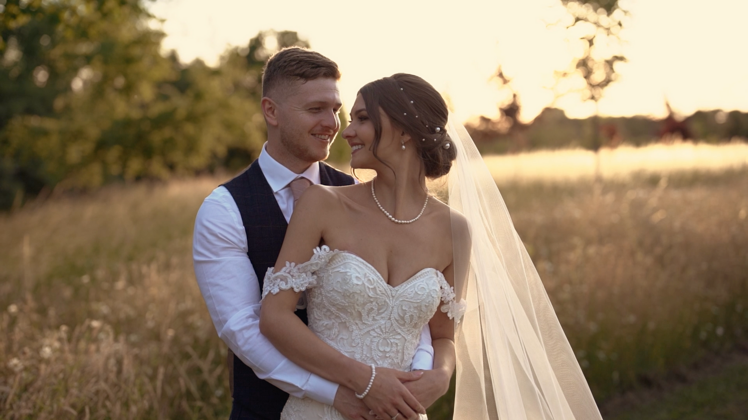 Romantic outdoor wedding photography session at golden hour showing tender moments between newlyweds. Maidens Barn.