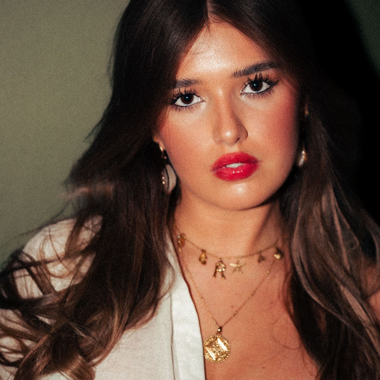 Portrait series featuring glamorous makeup look with red lipstick and gold jewellery.  Harwich, Essex.