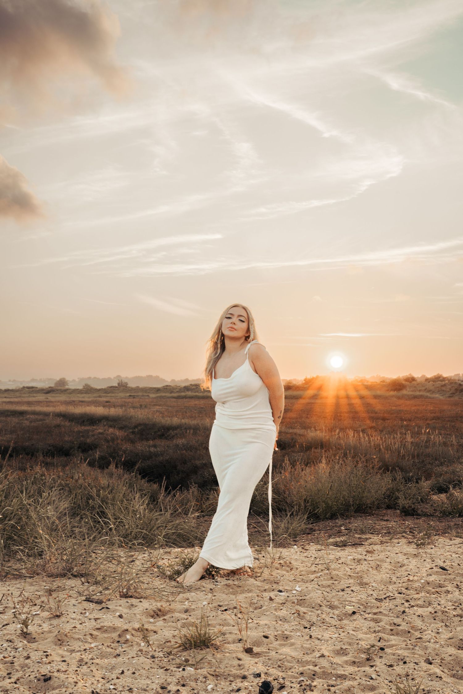 Sunset photoshoot in a desert landscape with warm golden light and dramatic poses. Earlhams Beach, Harwich, Essex.