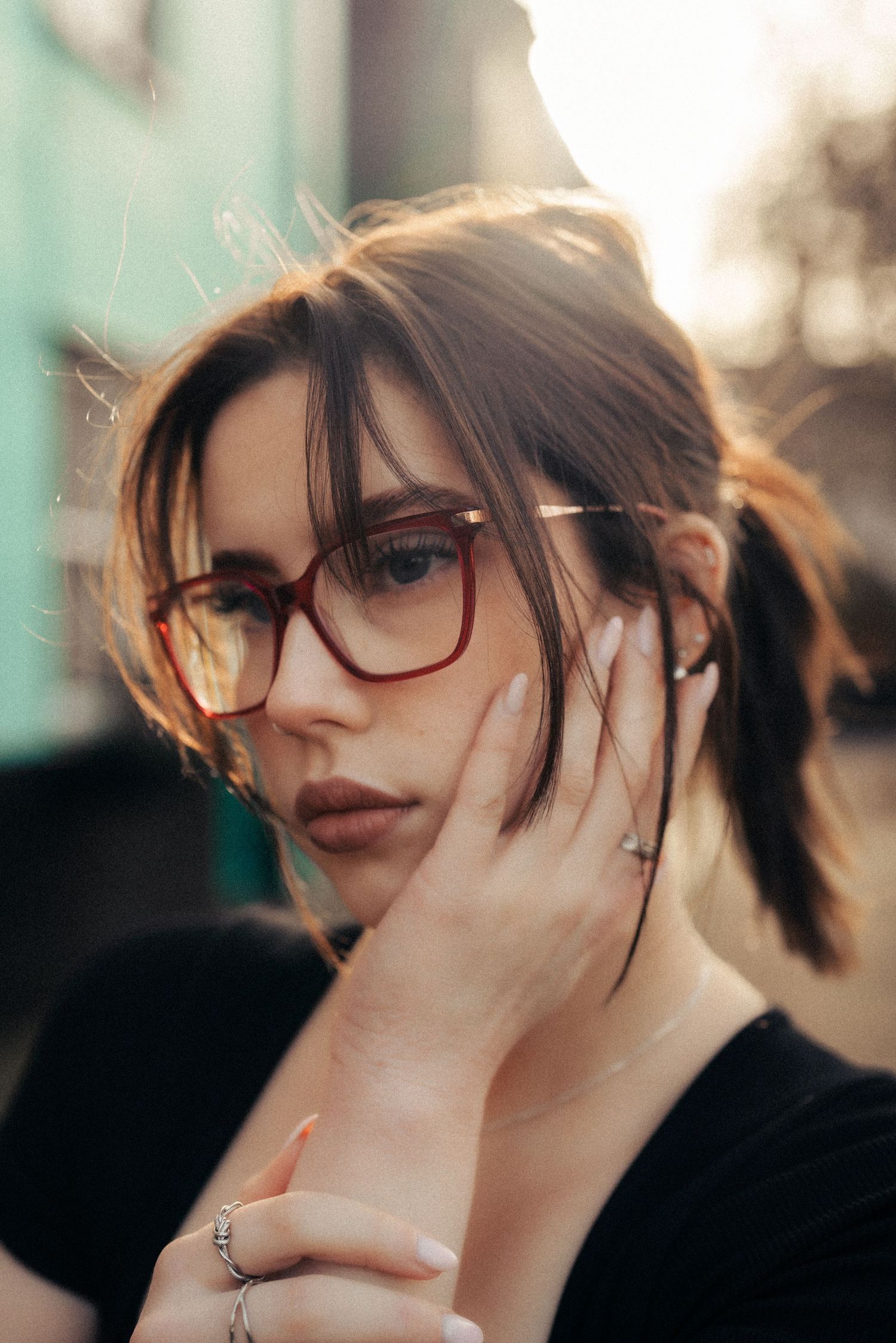 Moody portrait with glasses and windswept hair at sunset. Old Harwich, Essex.