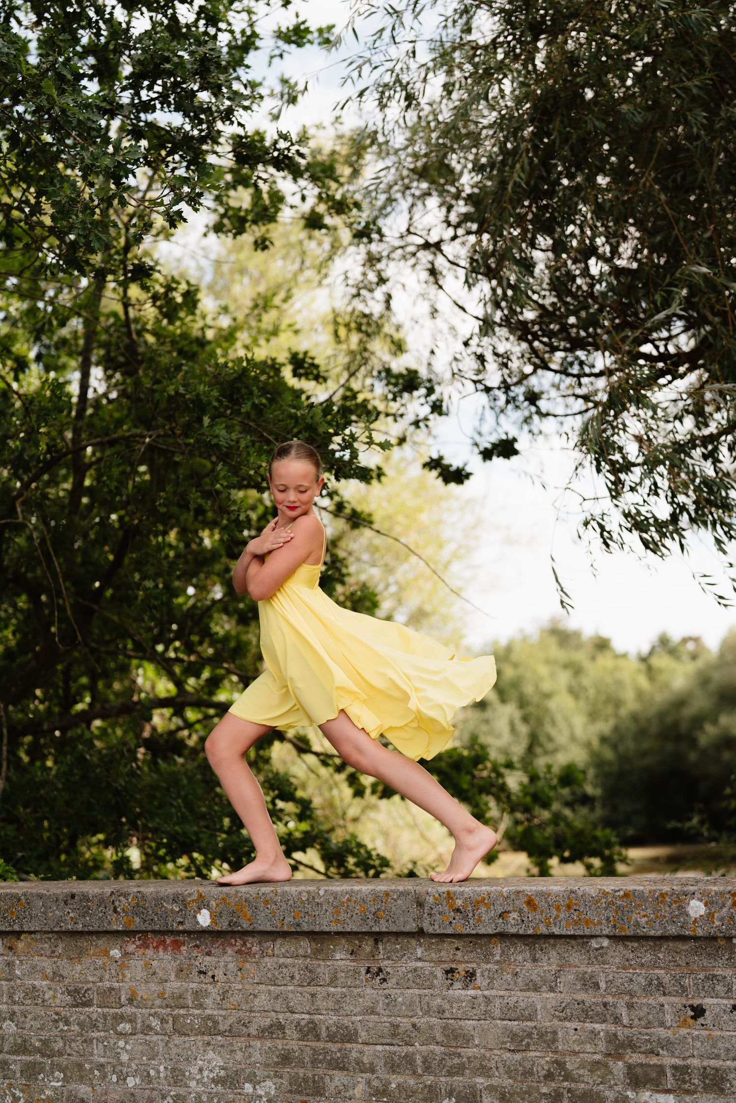A sequence showing a playful dance movement on a brick wall in a garden setting Manningtree, Essex.