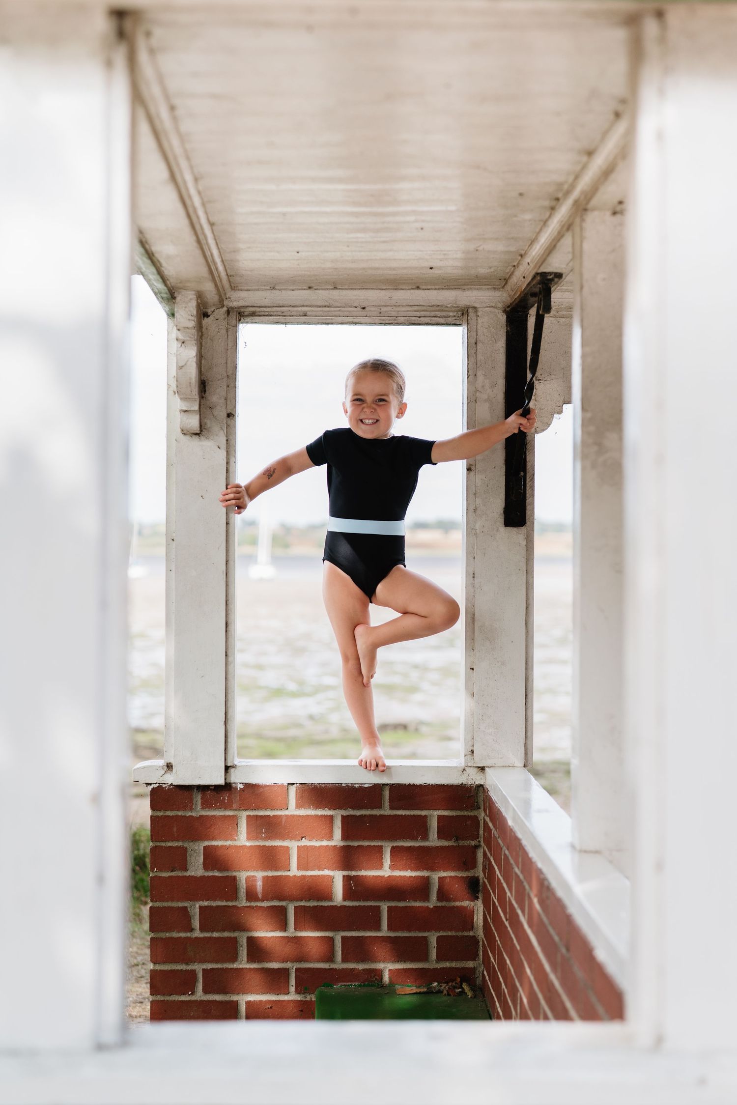Dynamic movements captured against a white-walled covered porch with brick accents. Manningtree, Essex.