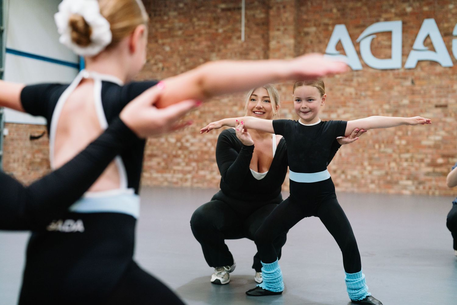 Students practicing dance moves in unison during a group fitness class. Manningtree, Essex.