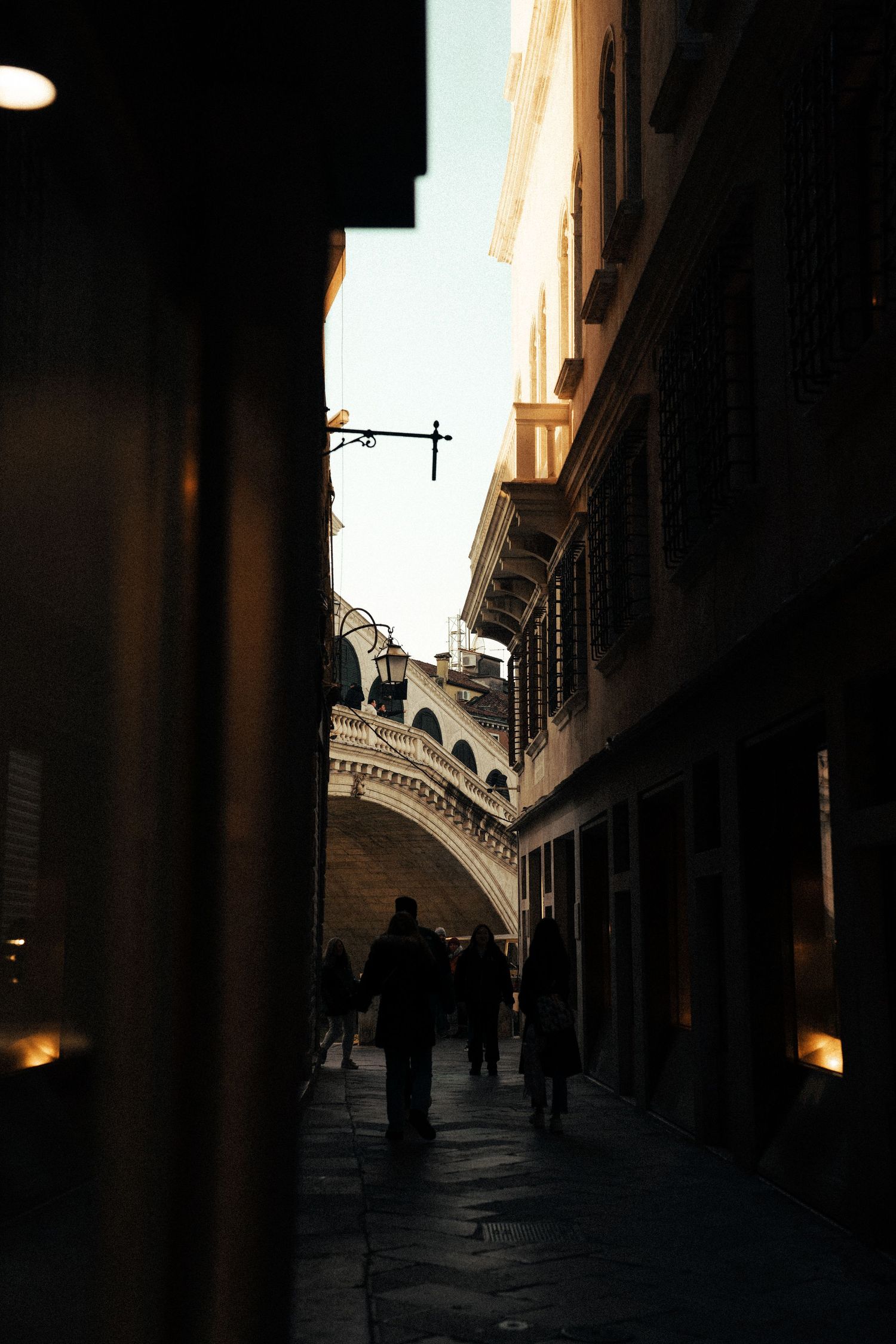 A dimly lit architectural corridor with arched ceiling and dramatic shadows. Location Venice, Italy.