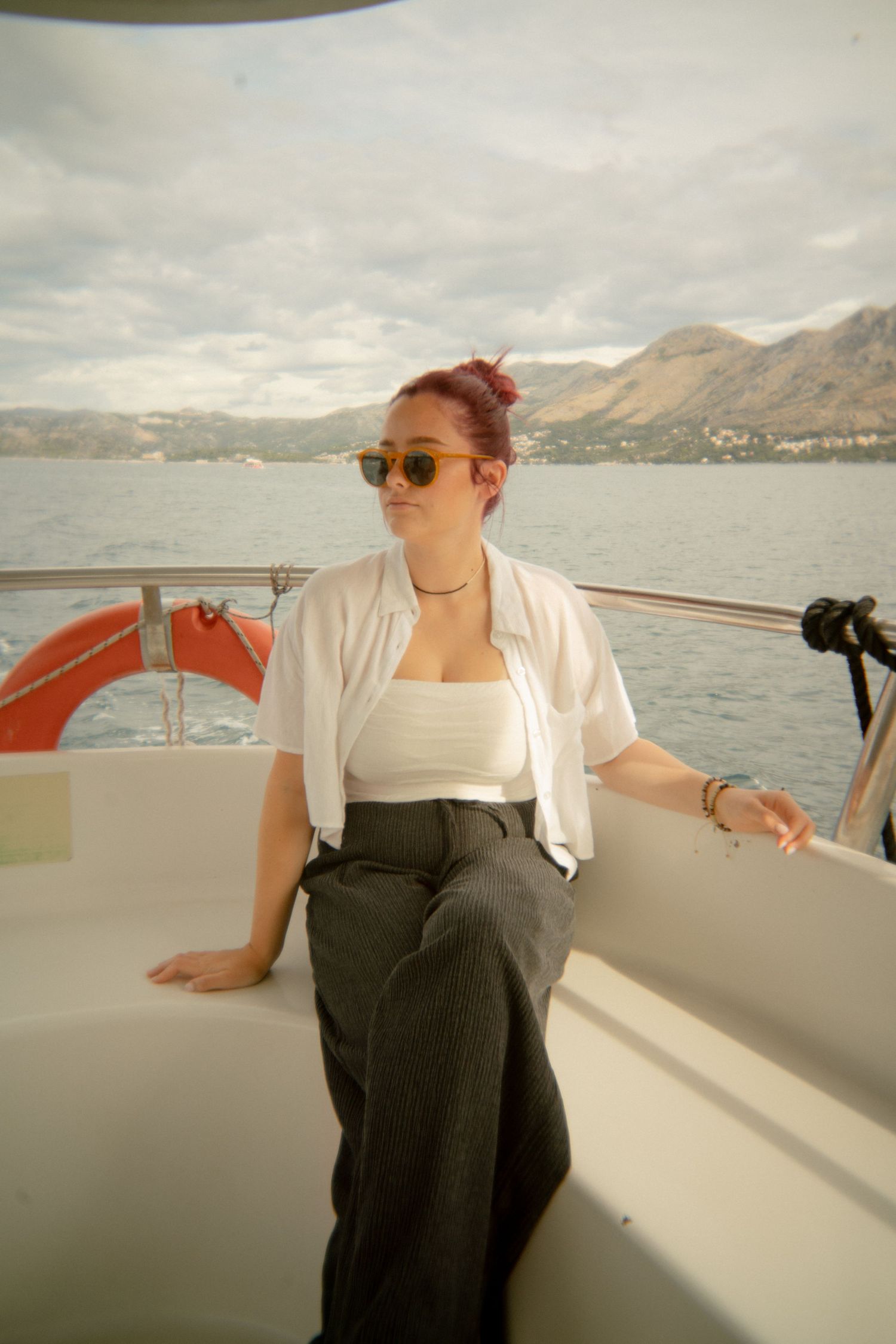 Woman enjoying a boat ride on a scenic mountain lake. Croatia.
