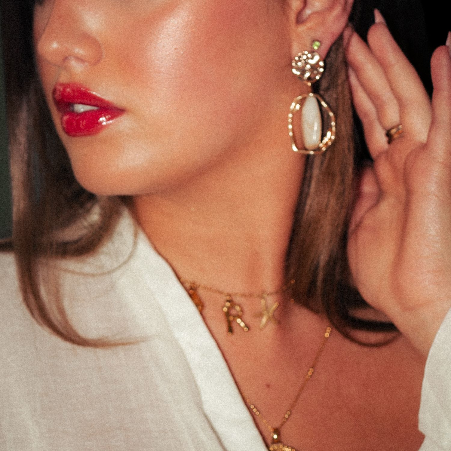 Close-up fashion portrait with gold jewellery and white collared shirt.  Harwich, Essex.
