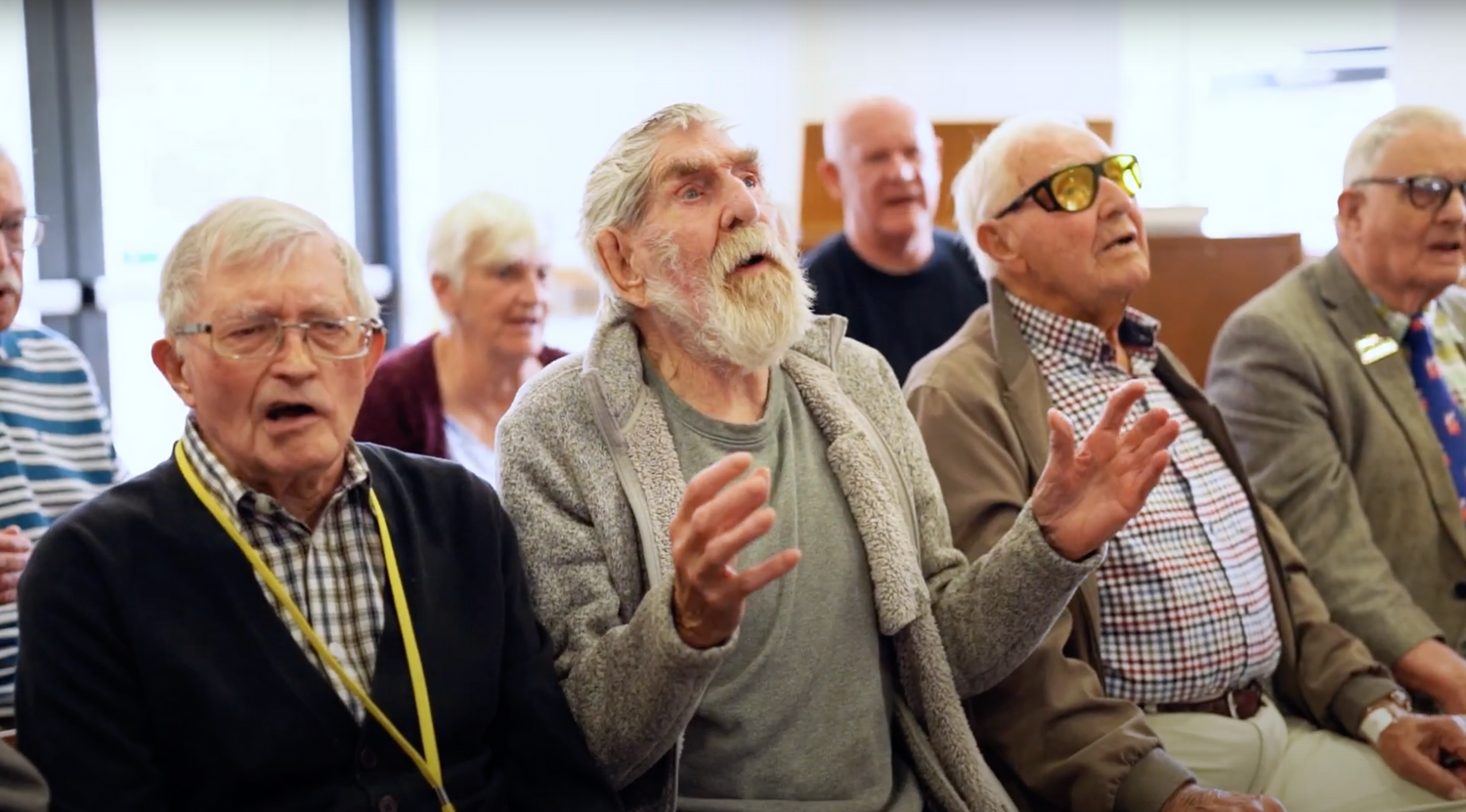 Veterans Sing choir singing together in their music session.