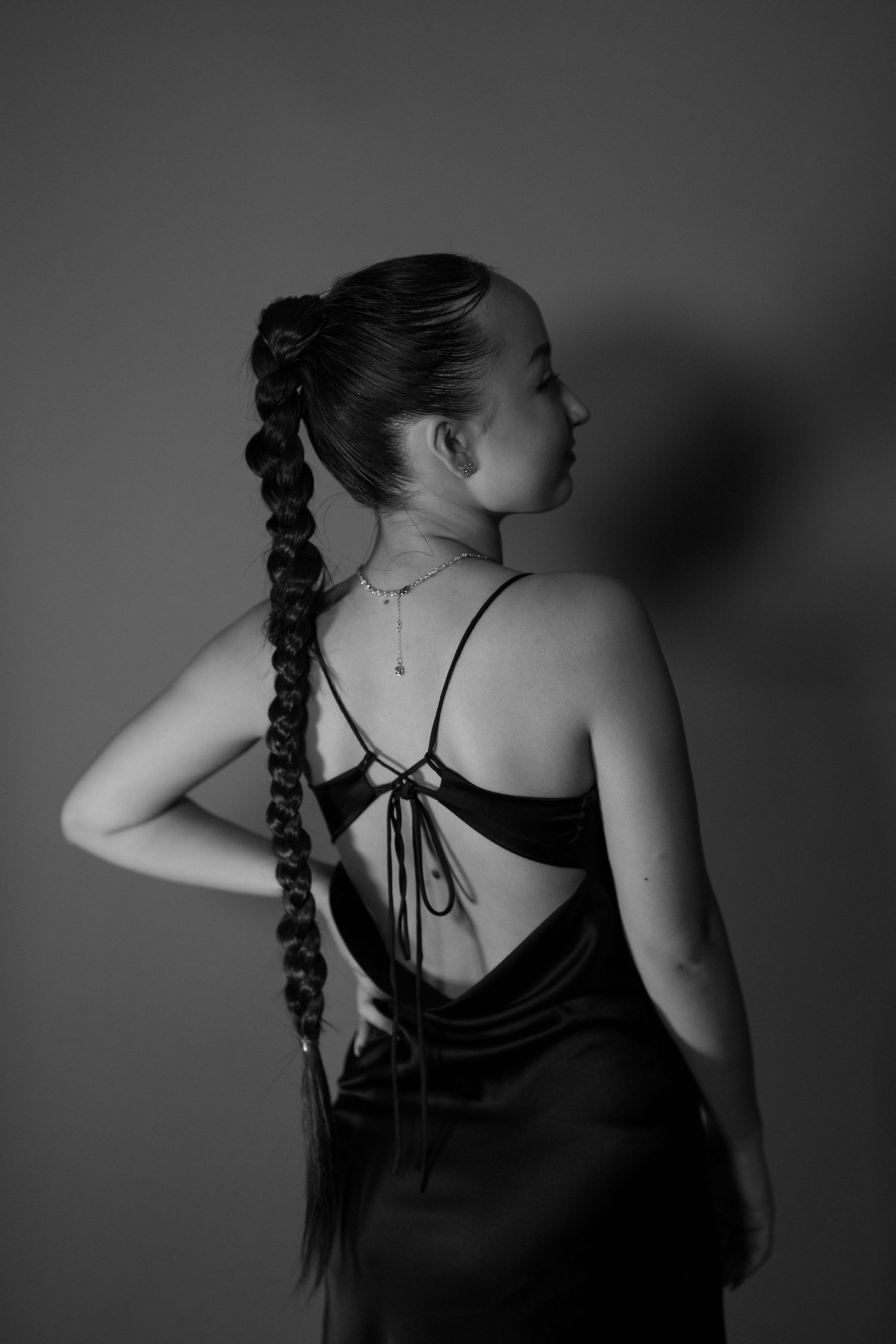 Dramatic black and white series showing braided hair and back details in studio lighting.