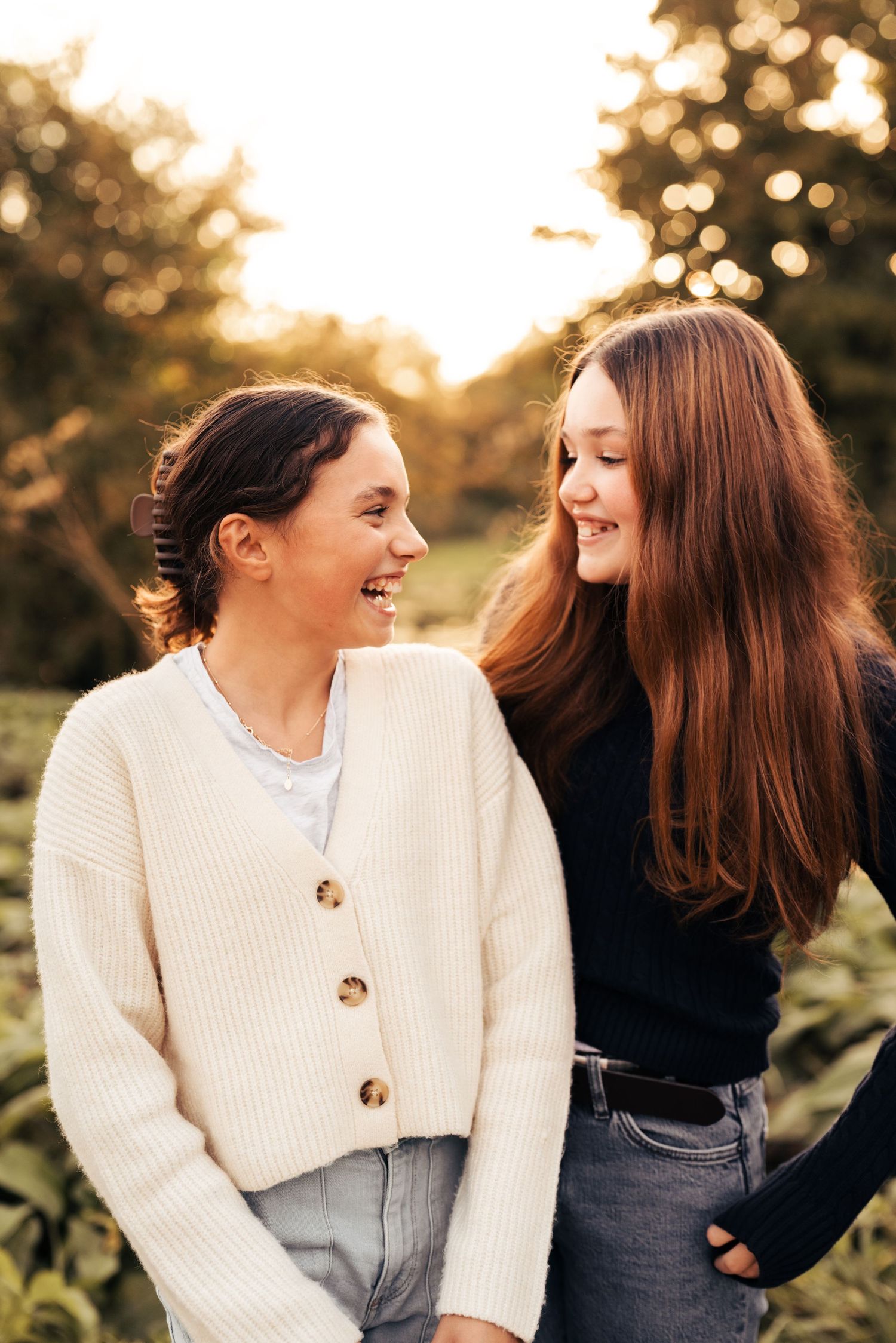 Two people in contrasting black and white sweaters share laughs during sunset. Flatford Mill.