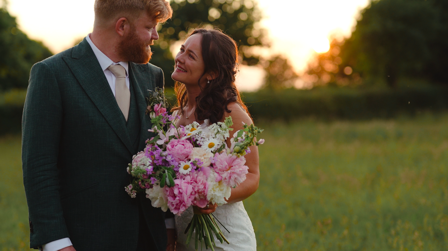 Romantic golden hour wedding photos in outdoor garden setting.