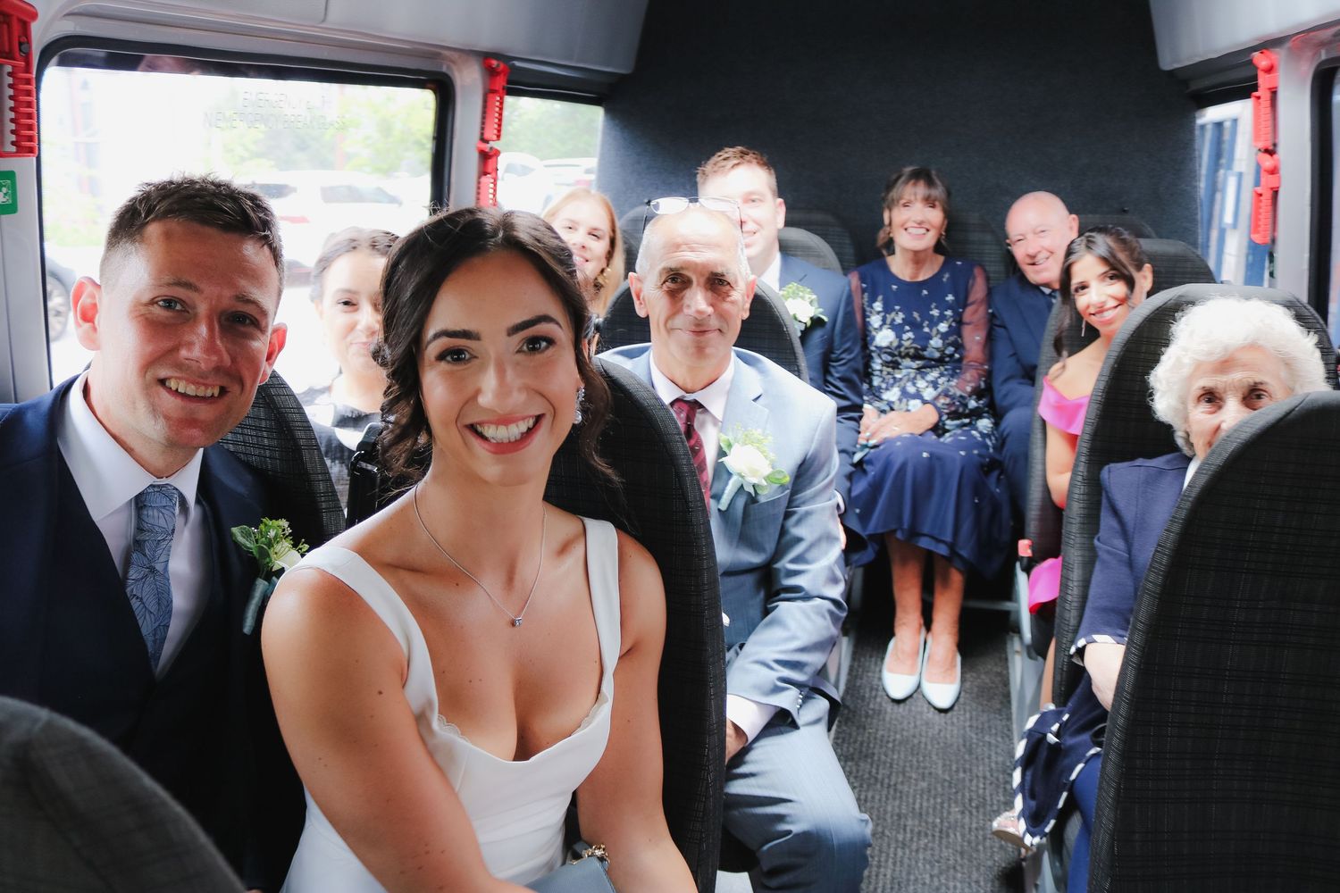 A happy couple shares a tender moment during their wedding ceremony, surrounded by guests.