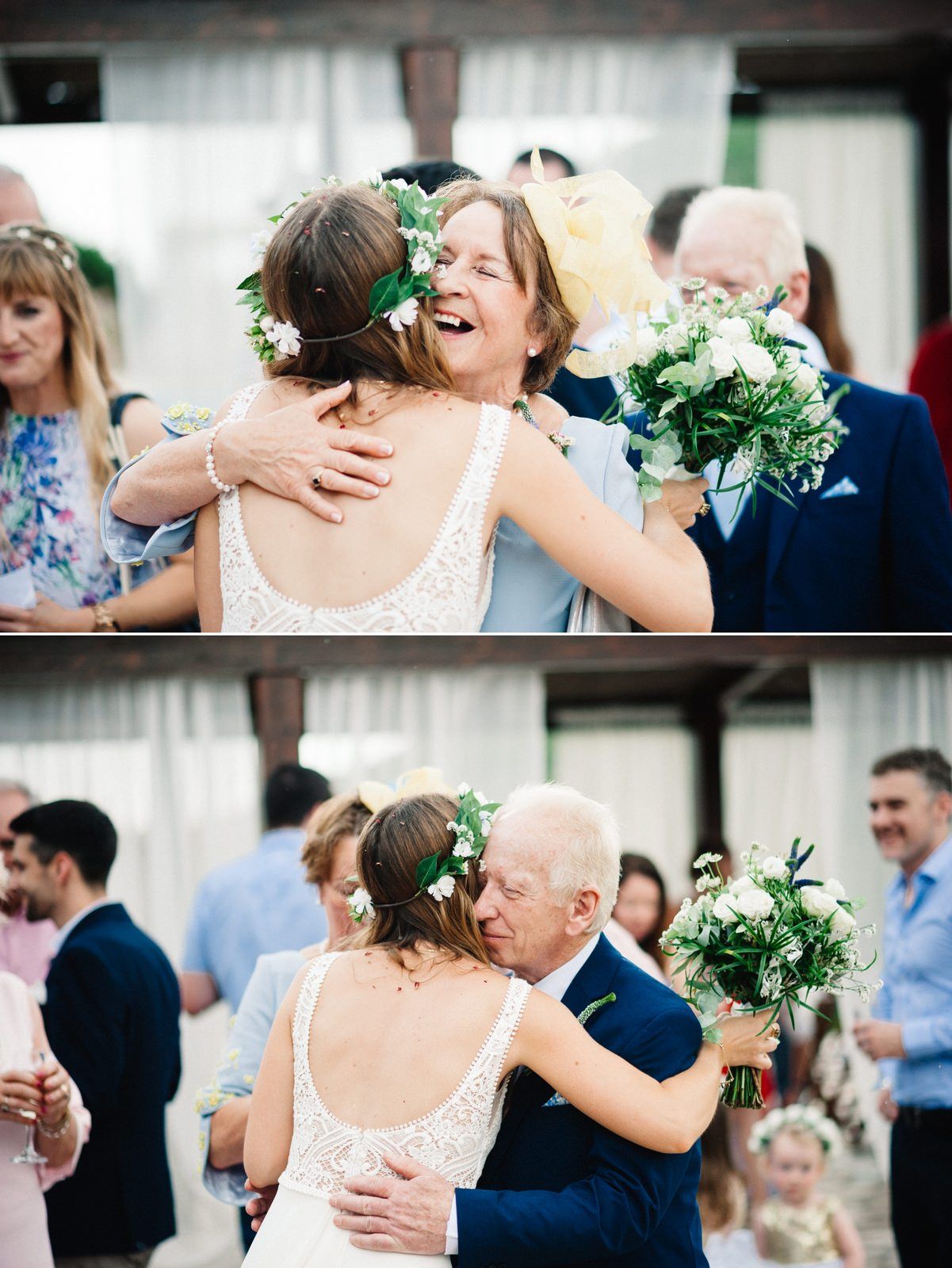 Emotional embrace during wedding reception with guests celebrating in background.