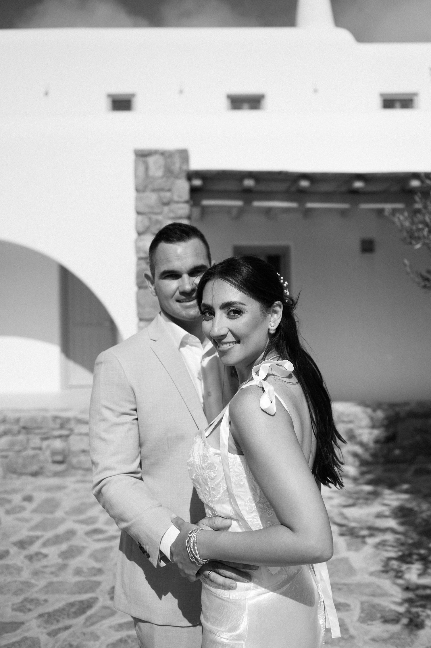 A couple embraces in black and white photography on their wedding day.