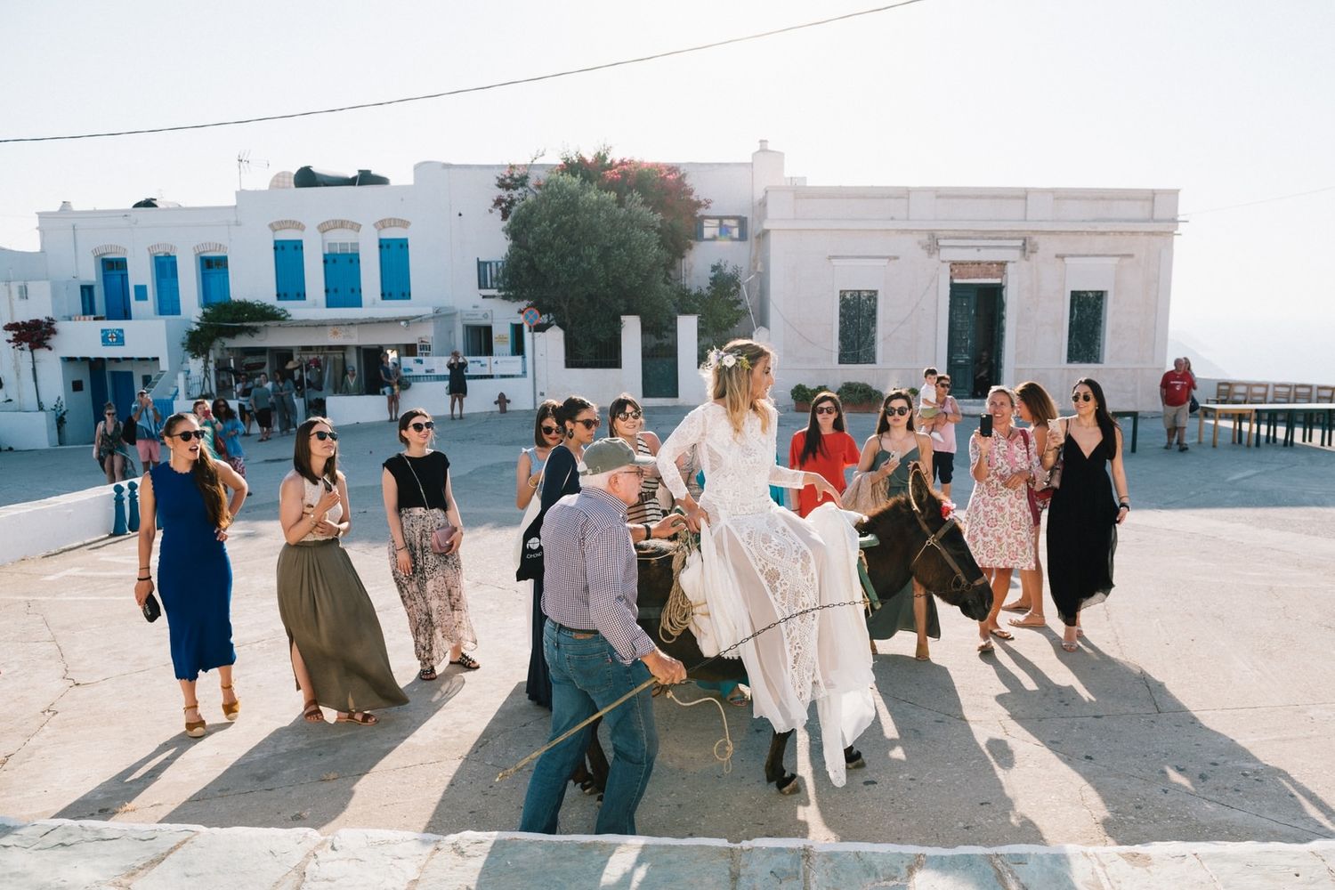 bride is on a donkey on her way to the church at folegandos