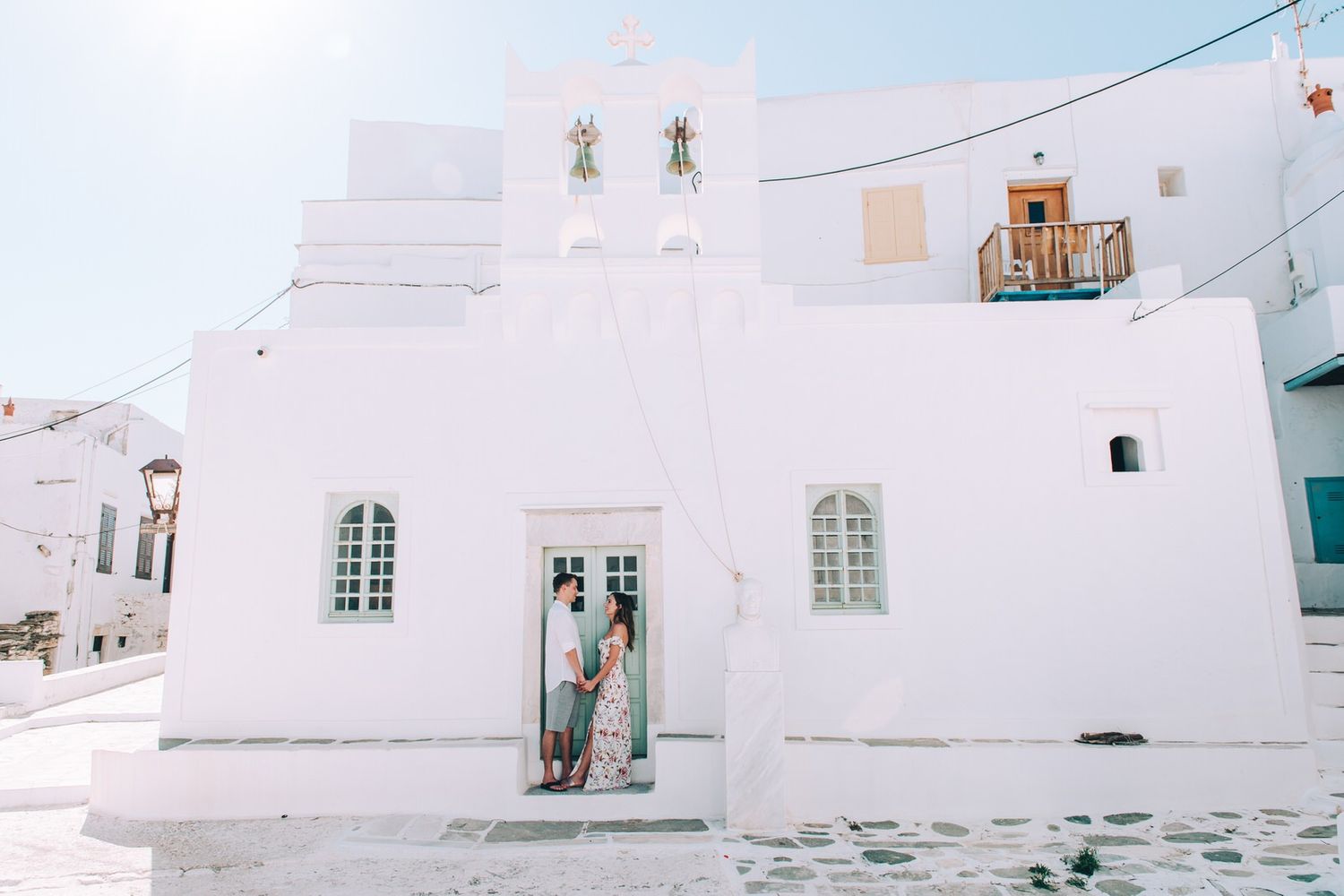 A pristine white Greek Orthodox church with traditional architecture and blue accents in the Mediterranean.