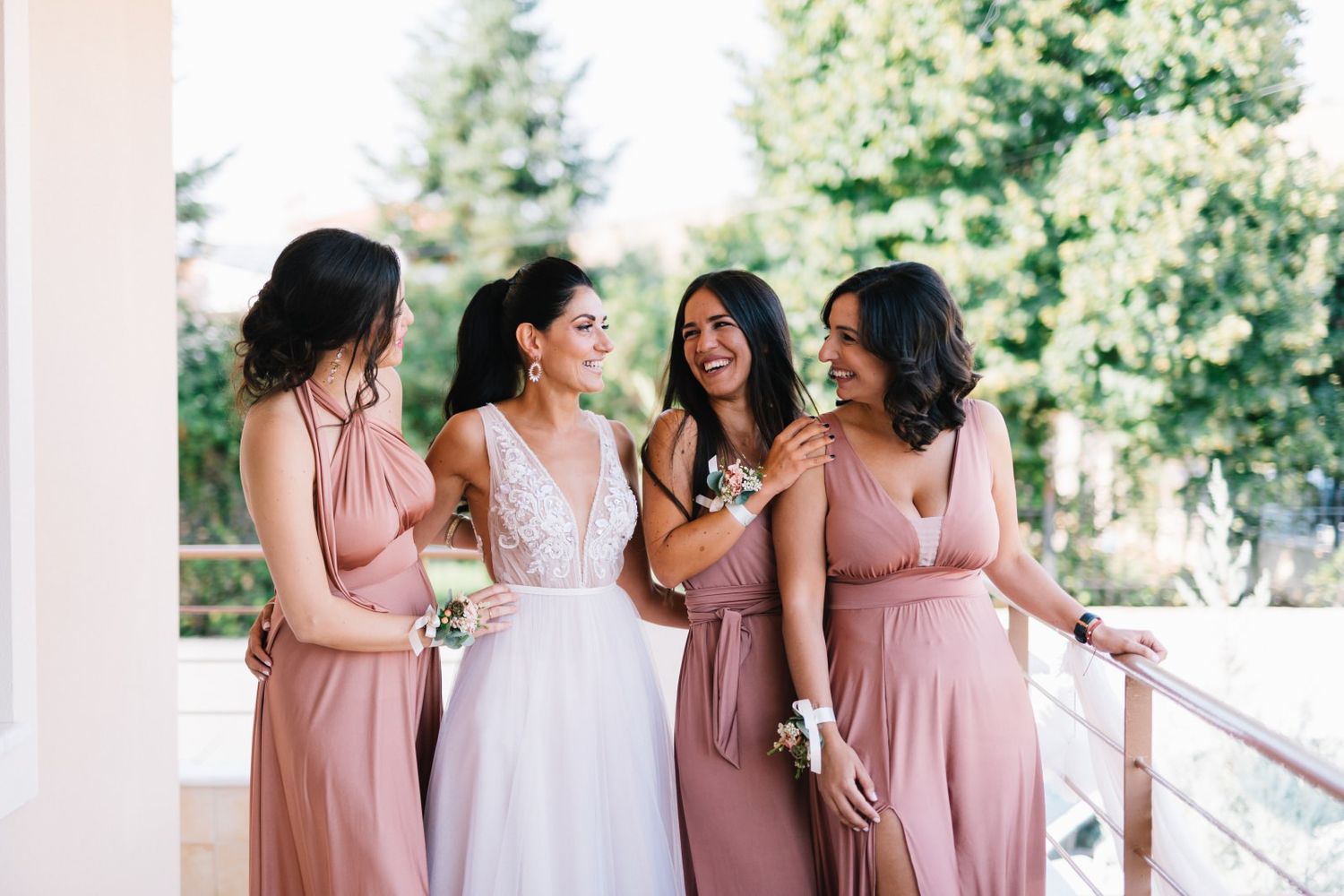 bride and bridesmaids smiling at portraits