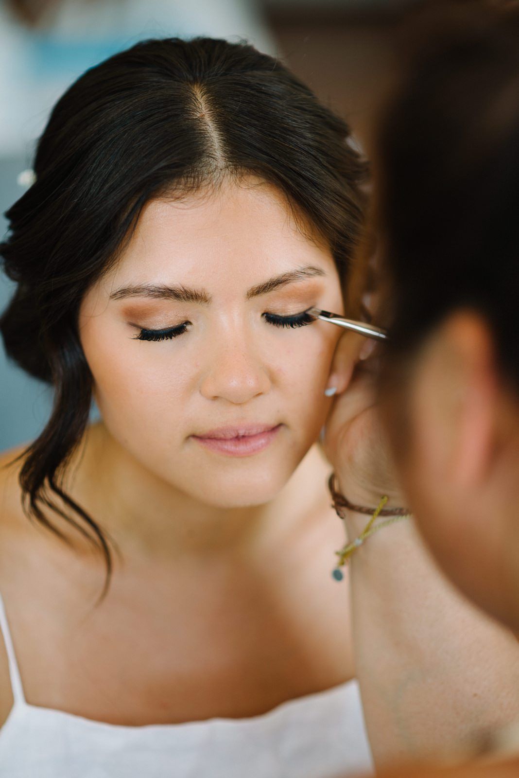 Close-up shot of bridal makeup application focusing on eye shadow.
