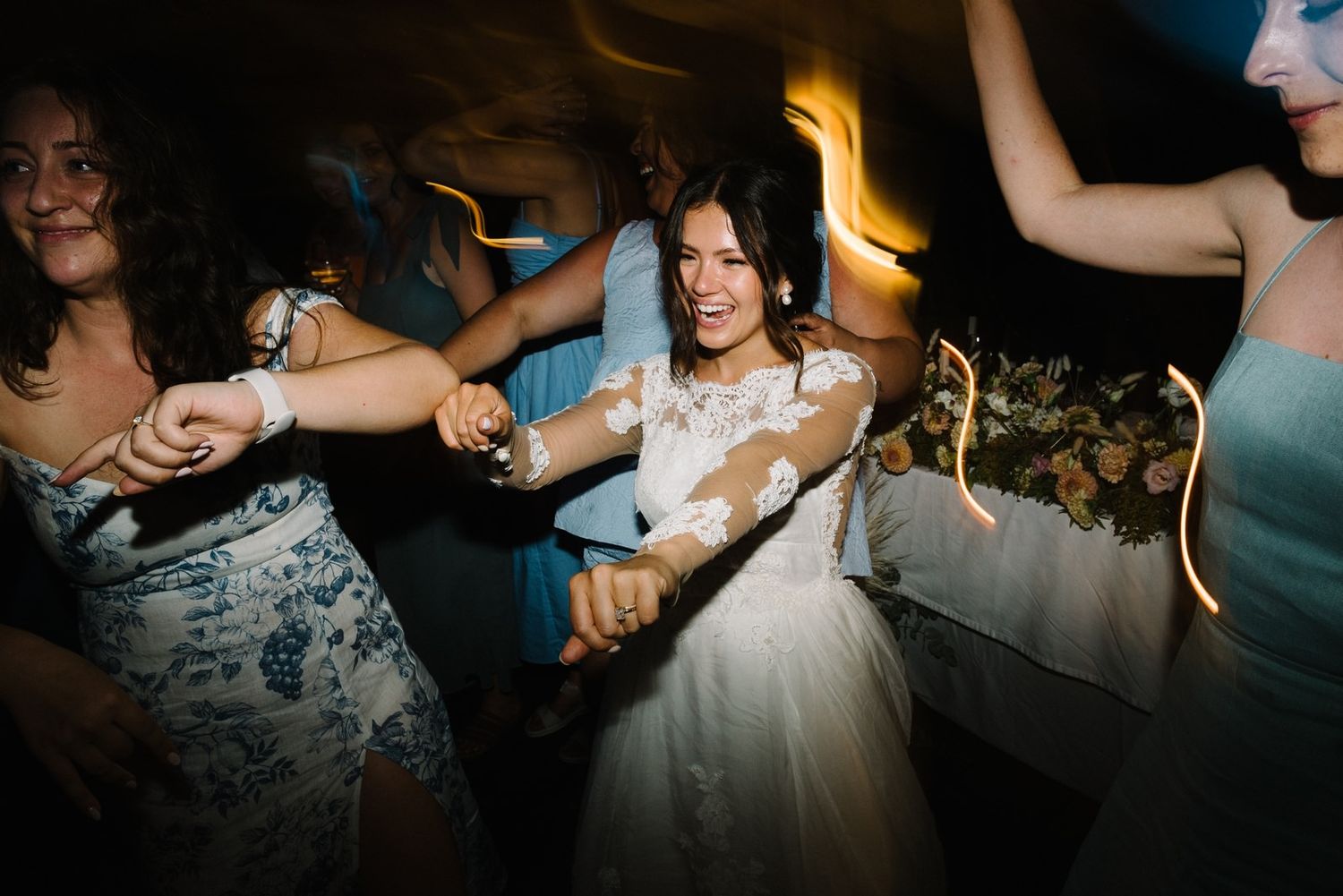 Wedding party dancing and celebrating during reception party.