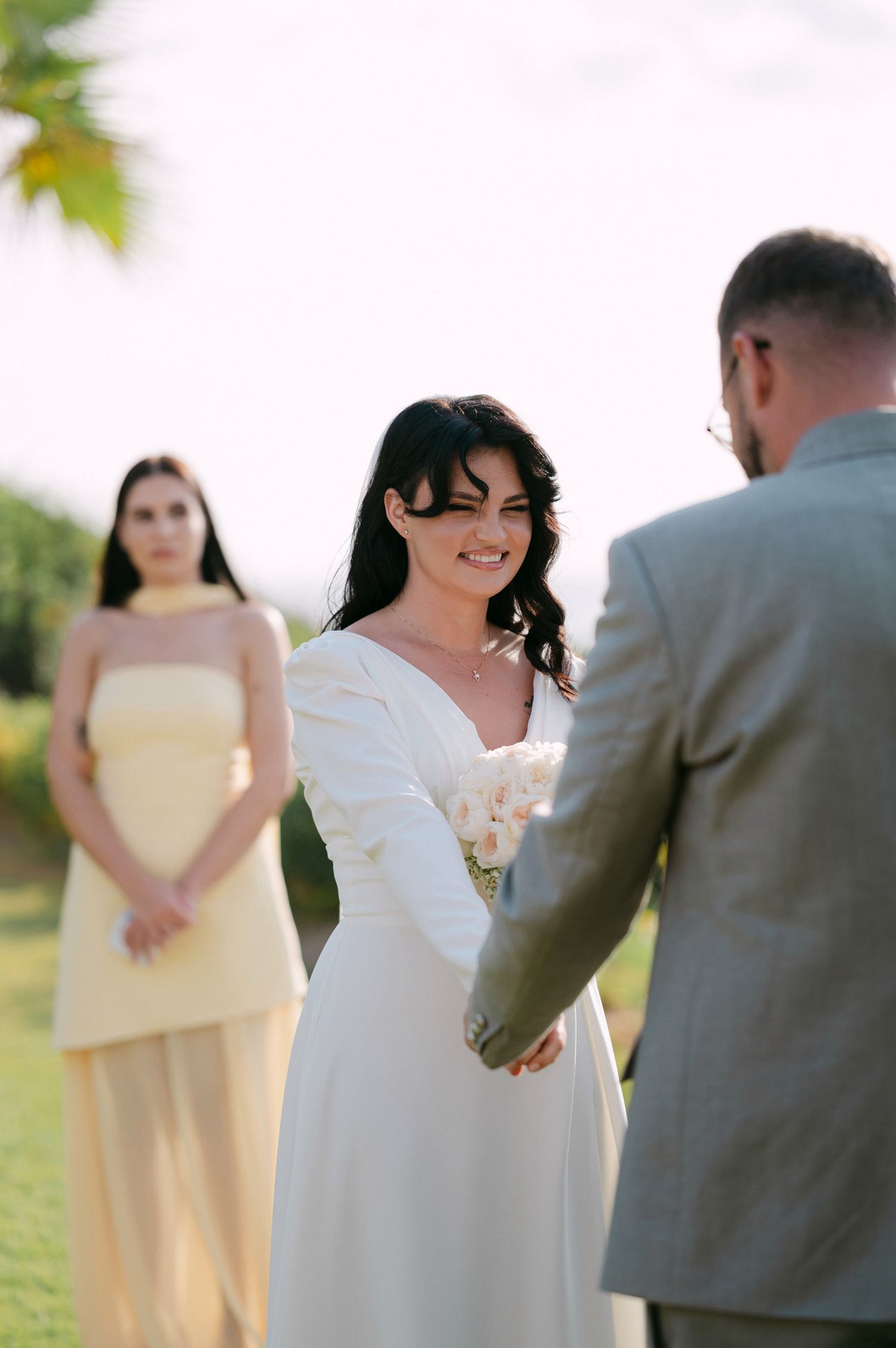 A series of candid wedding photos showing intimate moments between a couple during their outdoor ceremony.