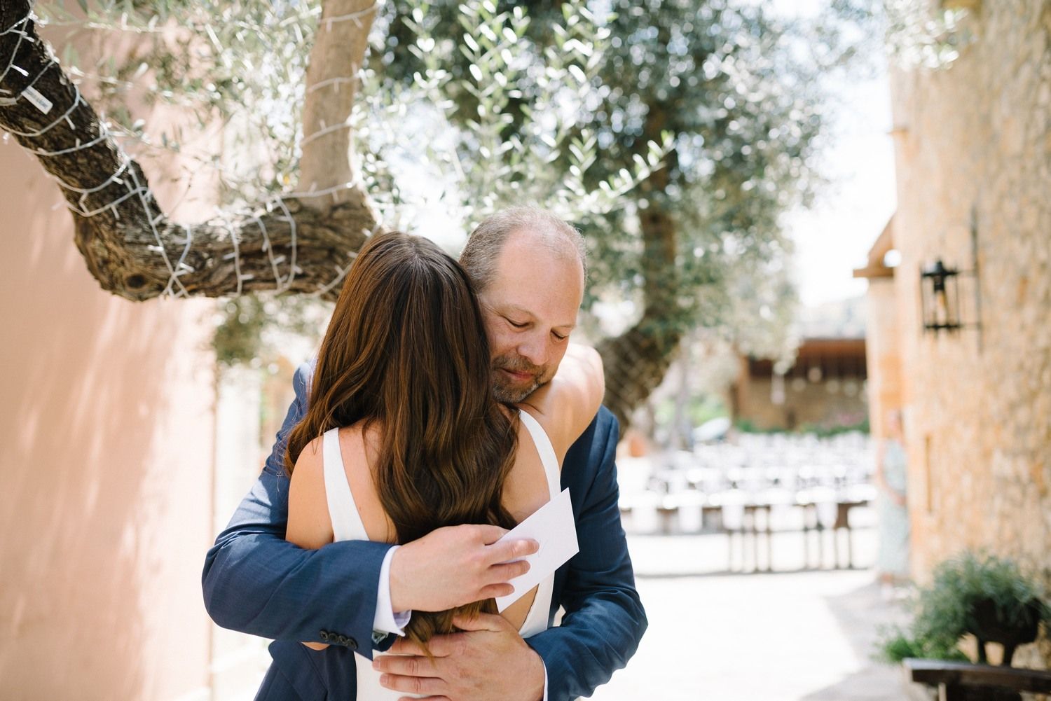 bride hugs her father before the wedding